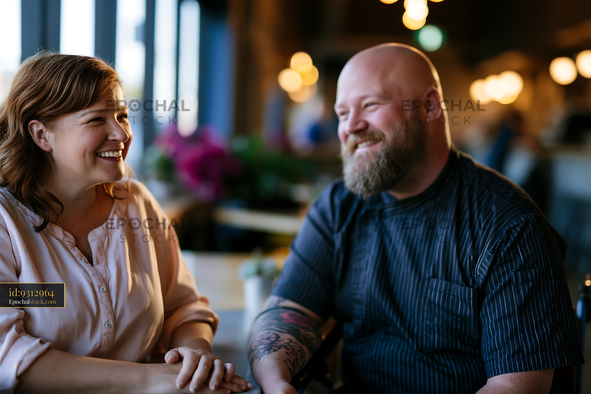 Watermarked full-resolution preview of Two people smiling and talking in a cafe
