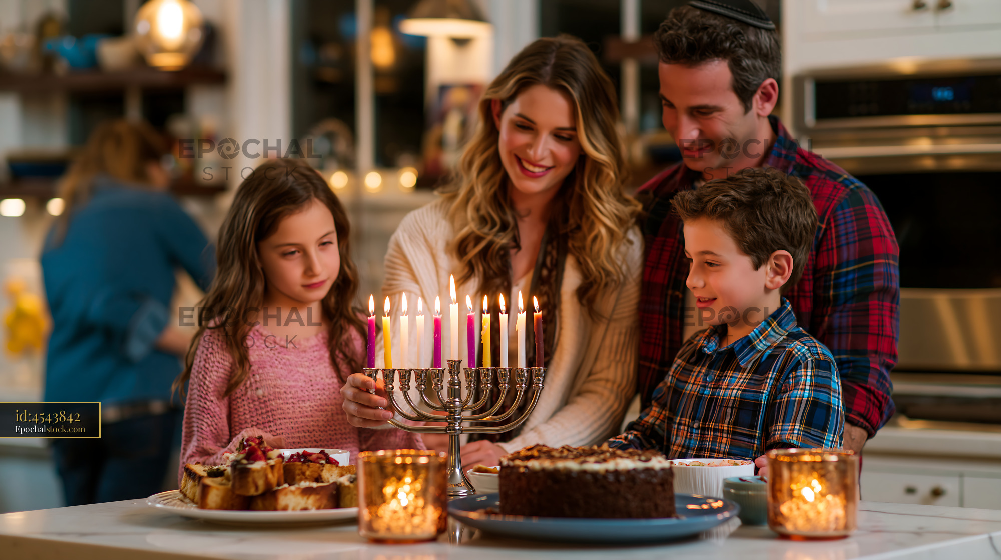 Watermarked full-resolution preview of Family celebrating a holiday with a menorah and desserts