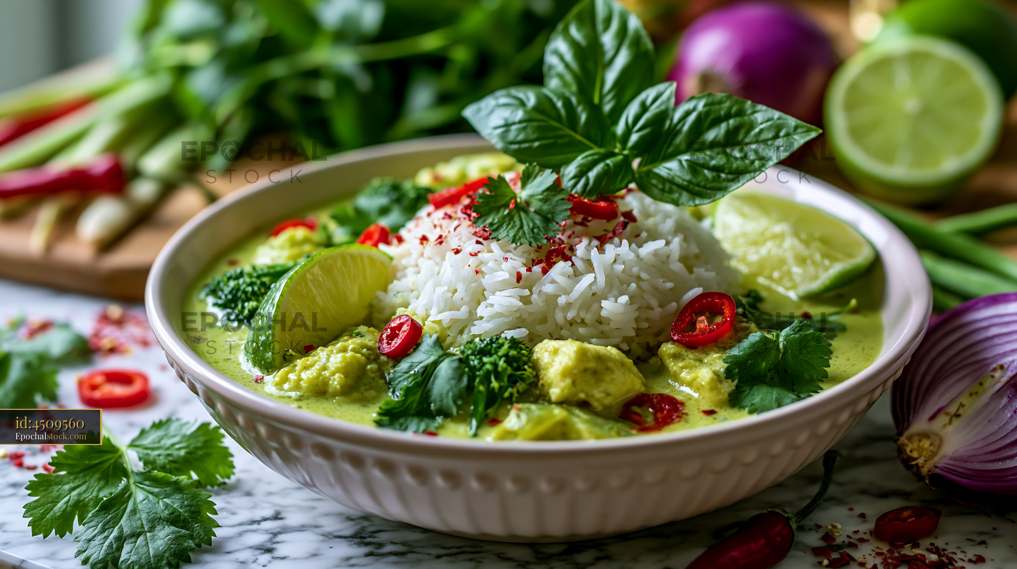 Watermarked full-resolution preview of Green curry with chicken, rice, and fresh ingredients on a table