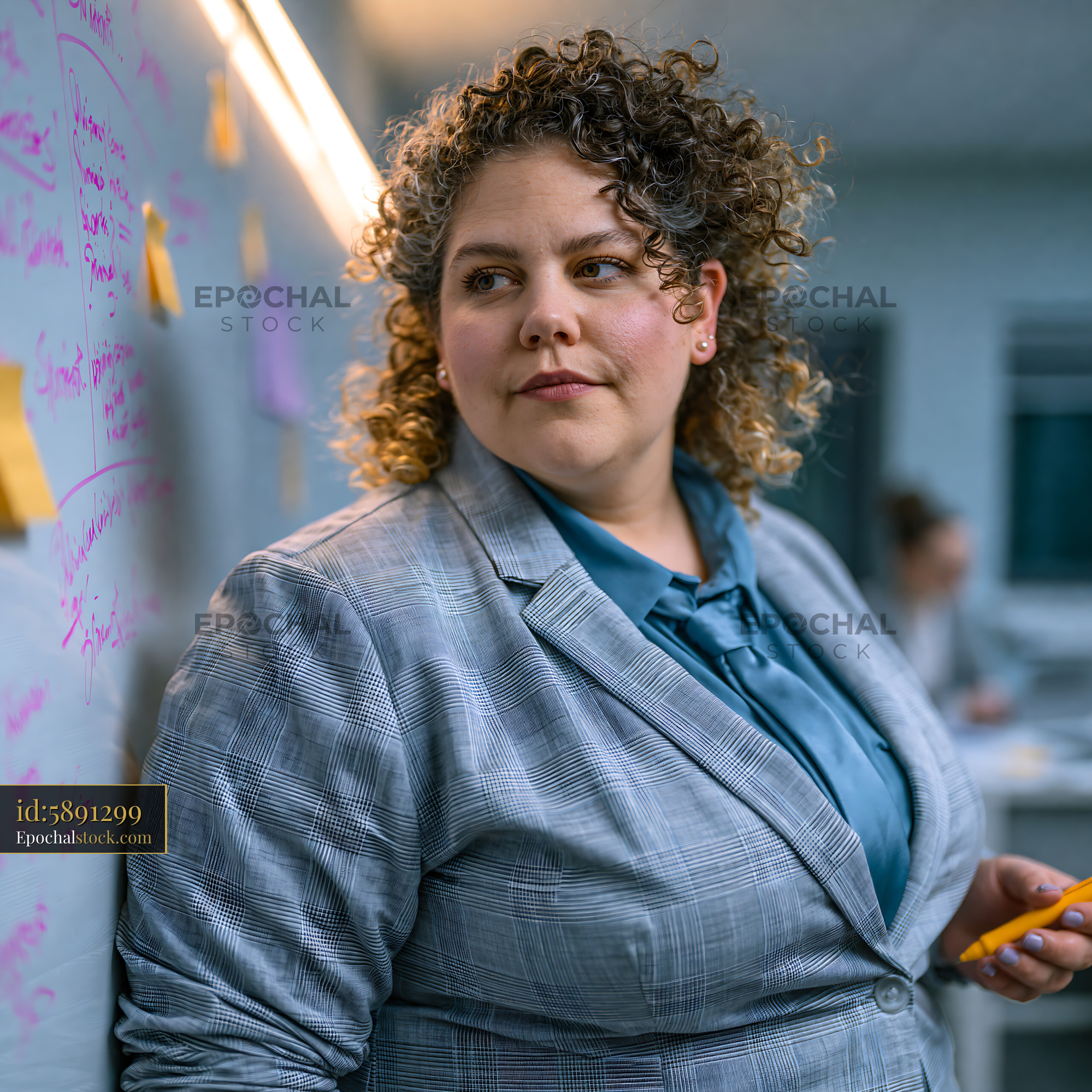 Watermarked full-resolution preview of Businesswoman brainstorming ideas in a modern office