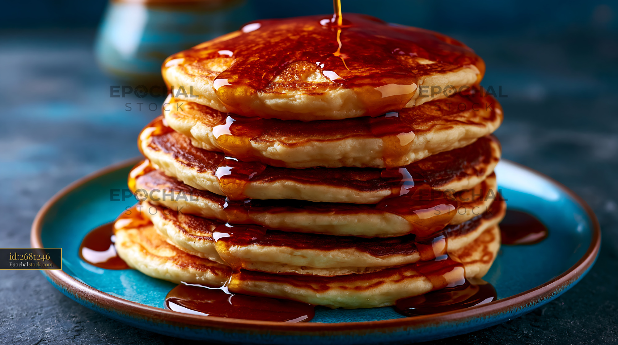Watermarked full-resolution preview of Stack of pancakes with syrup on a blue plate