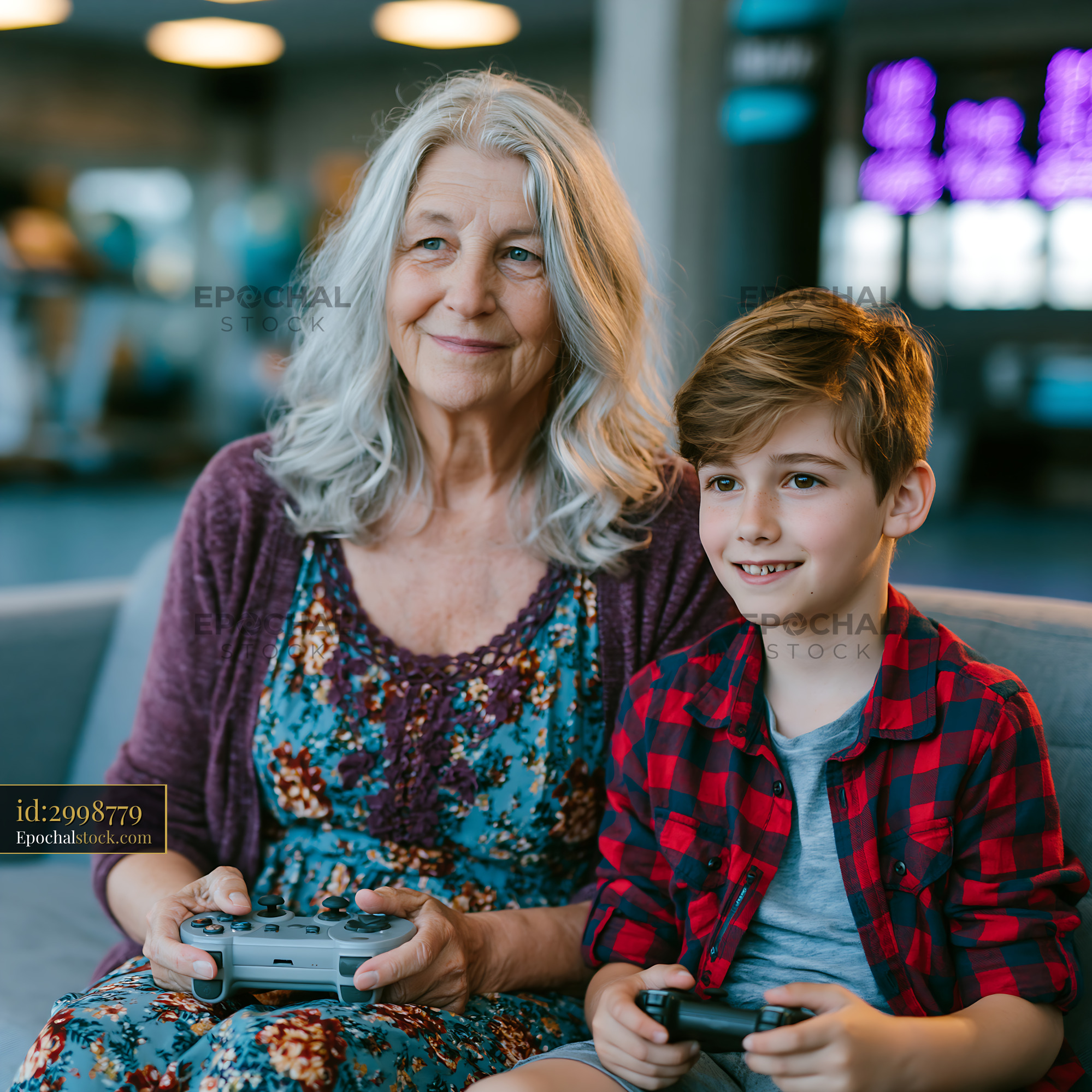 Watermarked full-resolution preview of Elderly woman and child playing video games in a public space