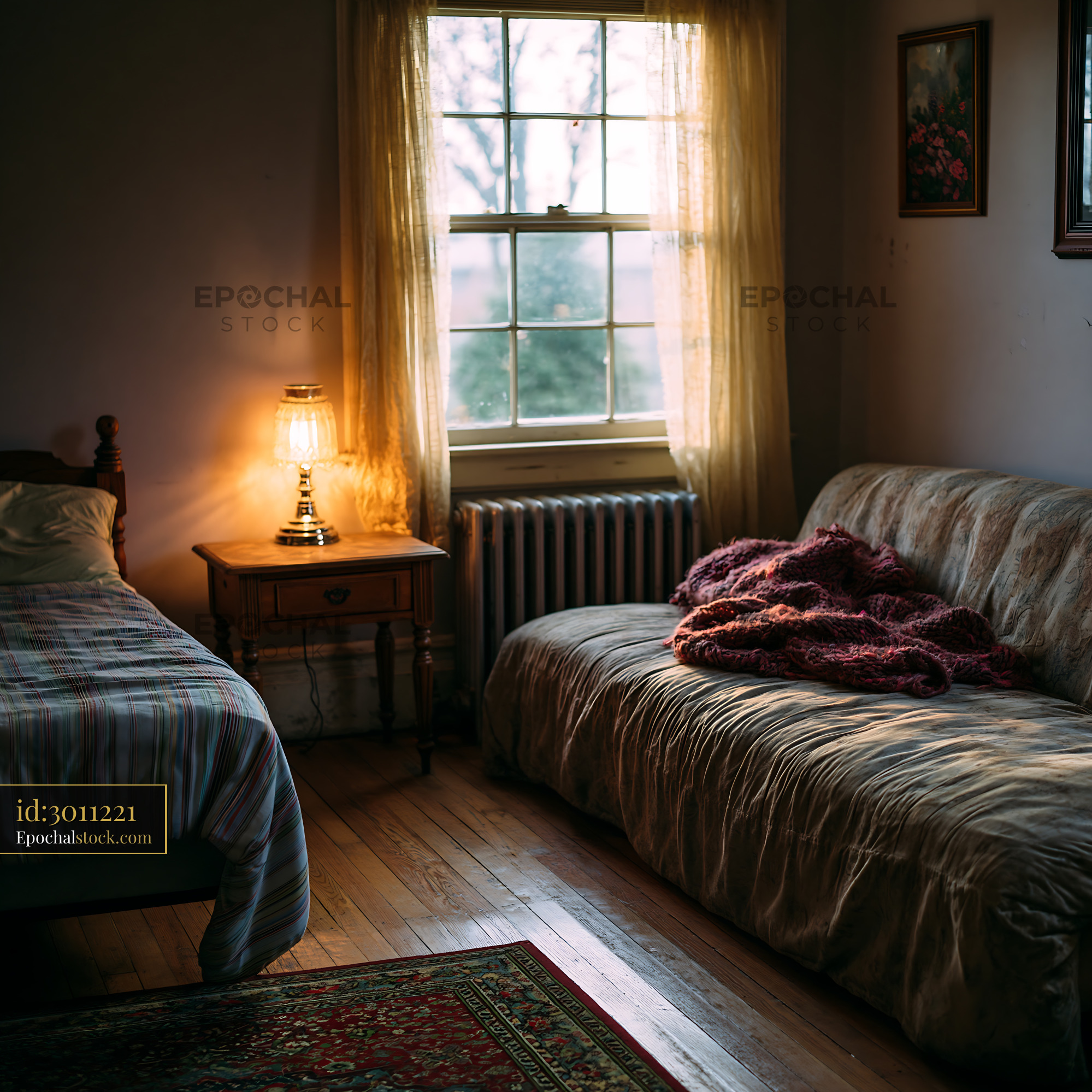 Sparse Room With a Single Bed and a Soft Couch by the Window - stock photo