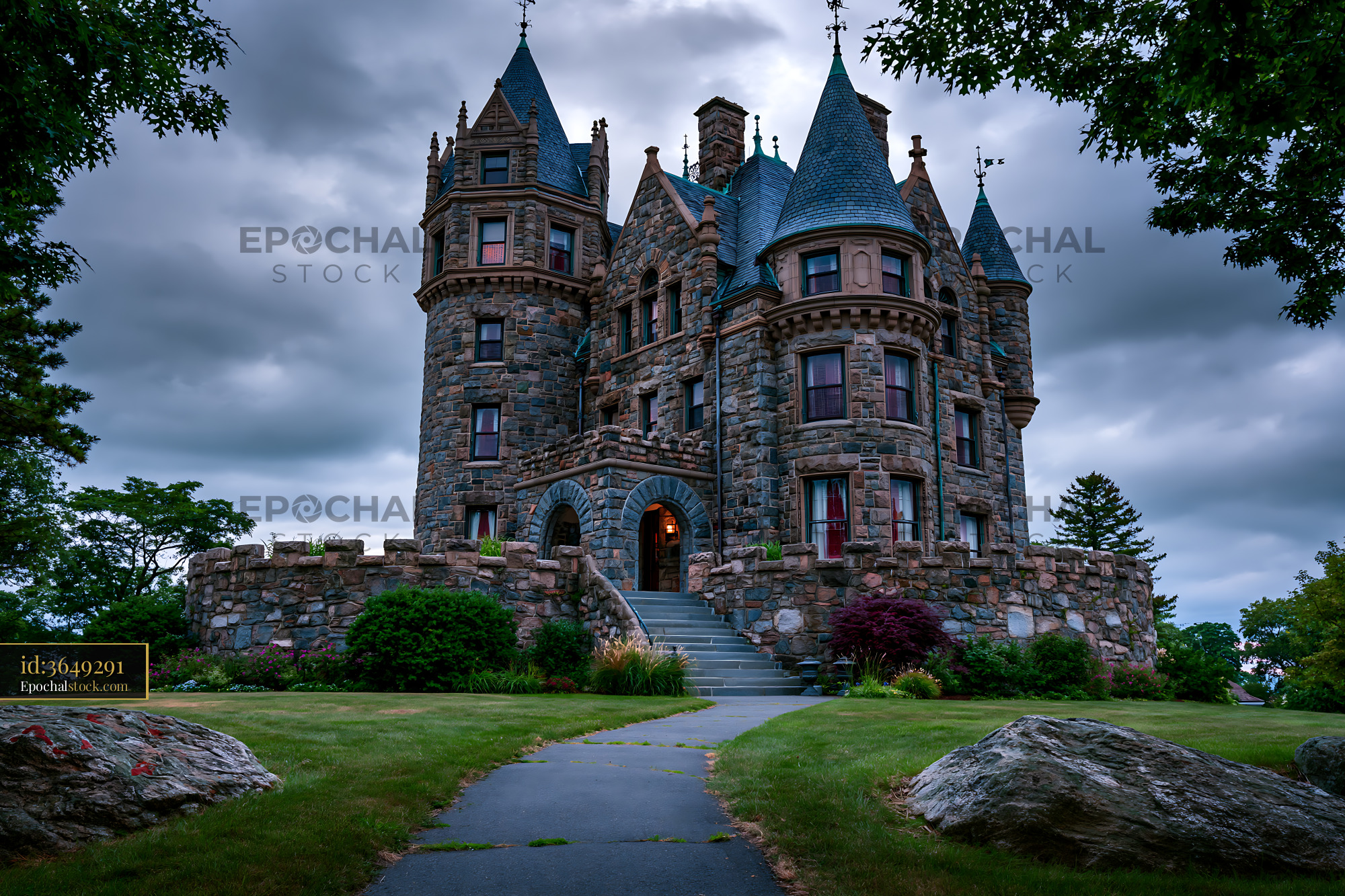 Watermarked full-resolution preview of Historic stone castle under a cloudy sky in a garden area