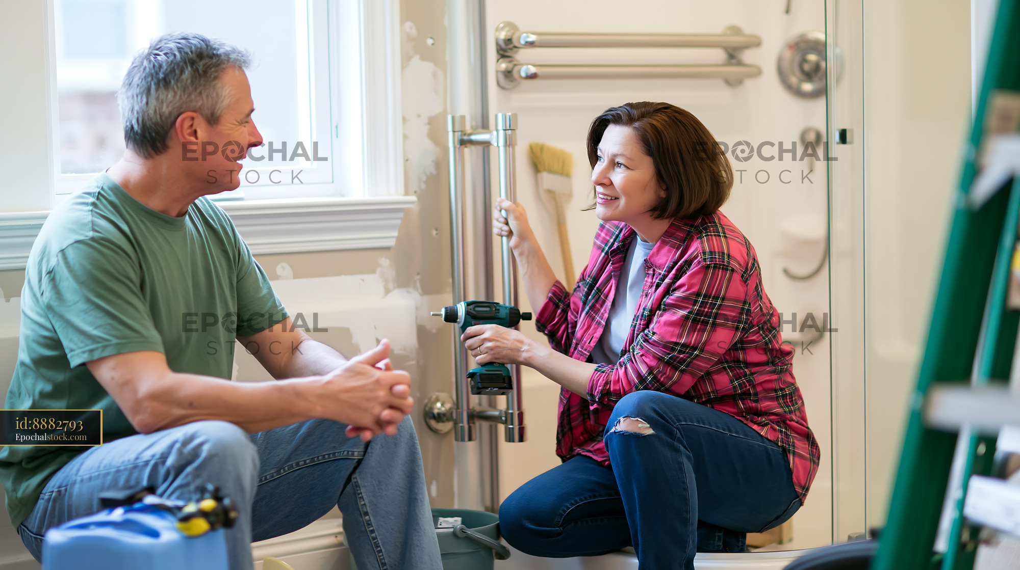 Watermarked full-resolution preview of Couple engaged in home renovation project together
