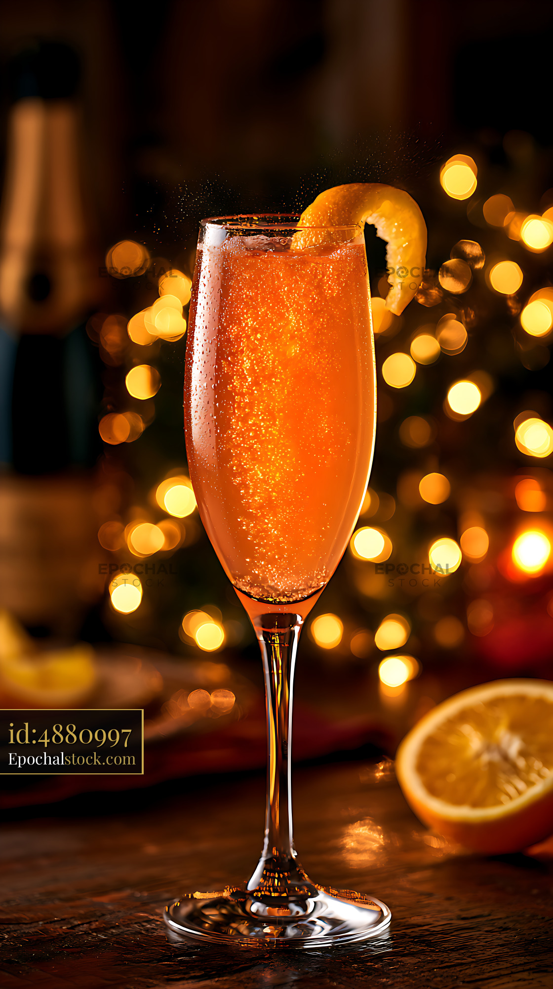 Watermarked full-resolution preview of Orange sparkling drink with citrus garnish and warm bokeh