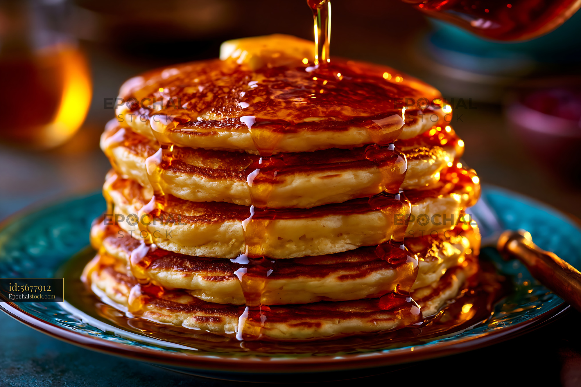 Watermarked full-resolution preview of Stacked pancakes with syrup and butter on a blue plate