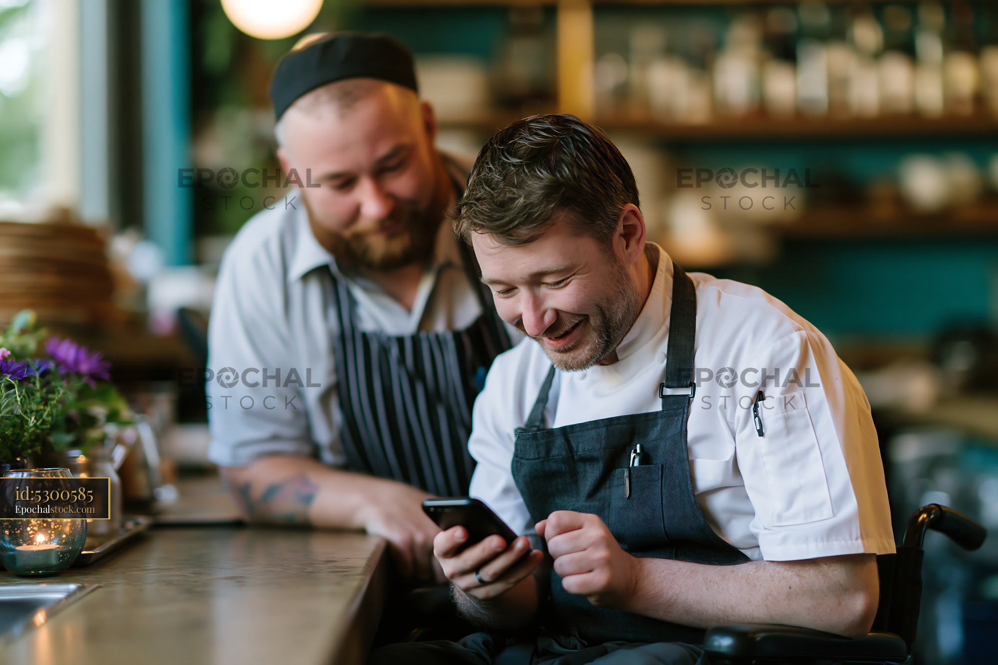 Watermarked full-resolution preview of Chefs smiling while looking at a phone in a restaurant