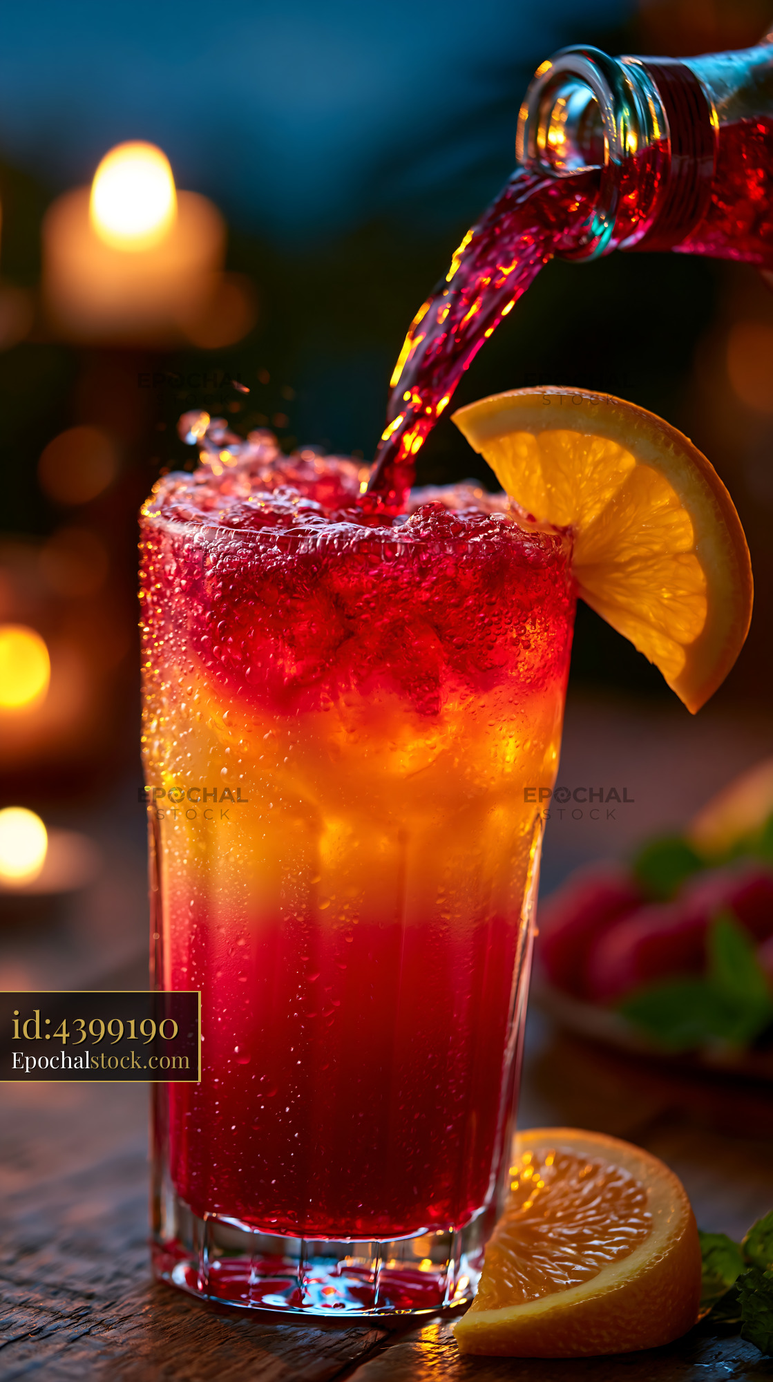 Watermarked full-resolution preview of Colorful drink being poured into a glass with fruit garnish