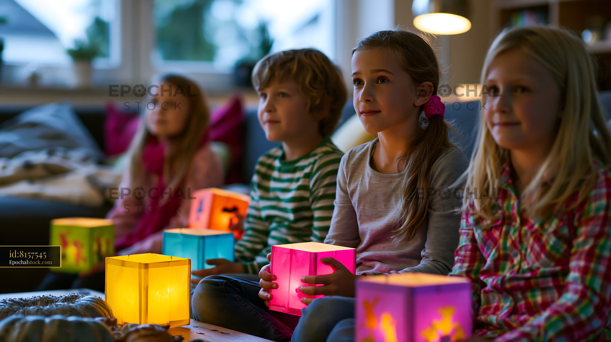 Watermarked full-resolution preview of Four children with colorful illuminated lanterns at home