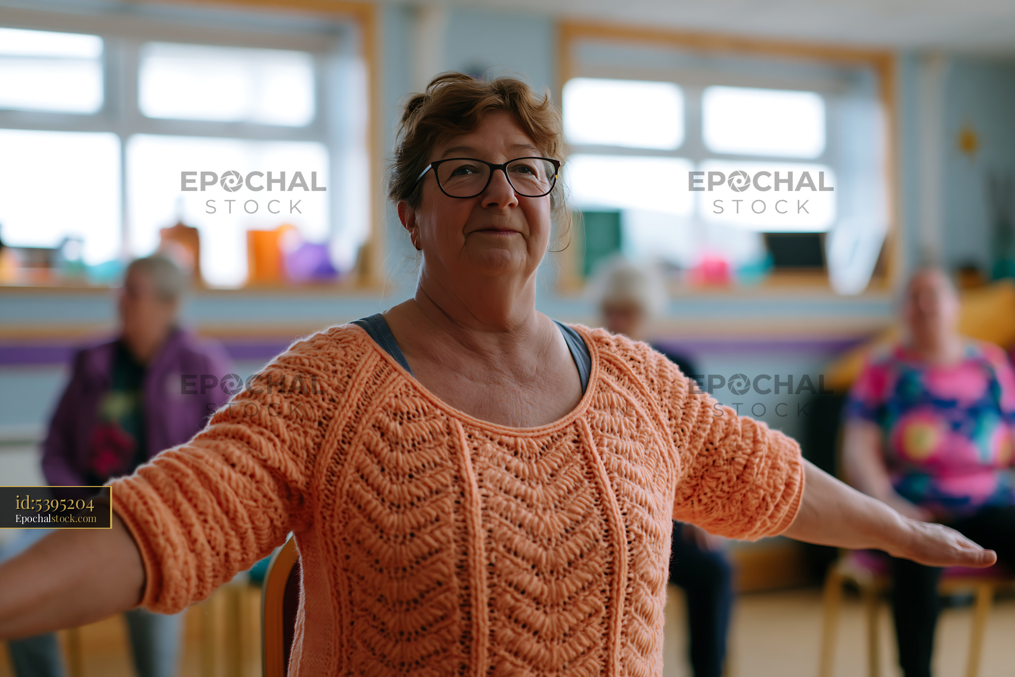 Watermarked full-resolution preview of Senior woman in a lively group exercise session