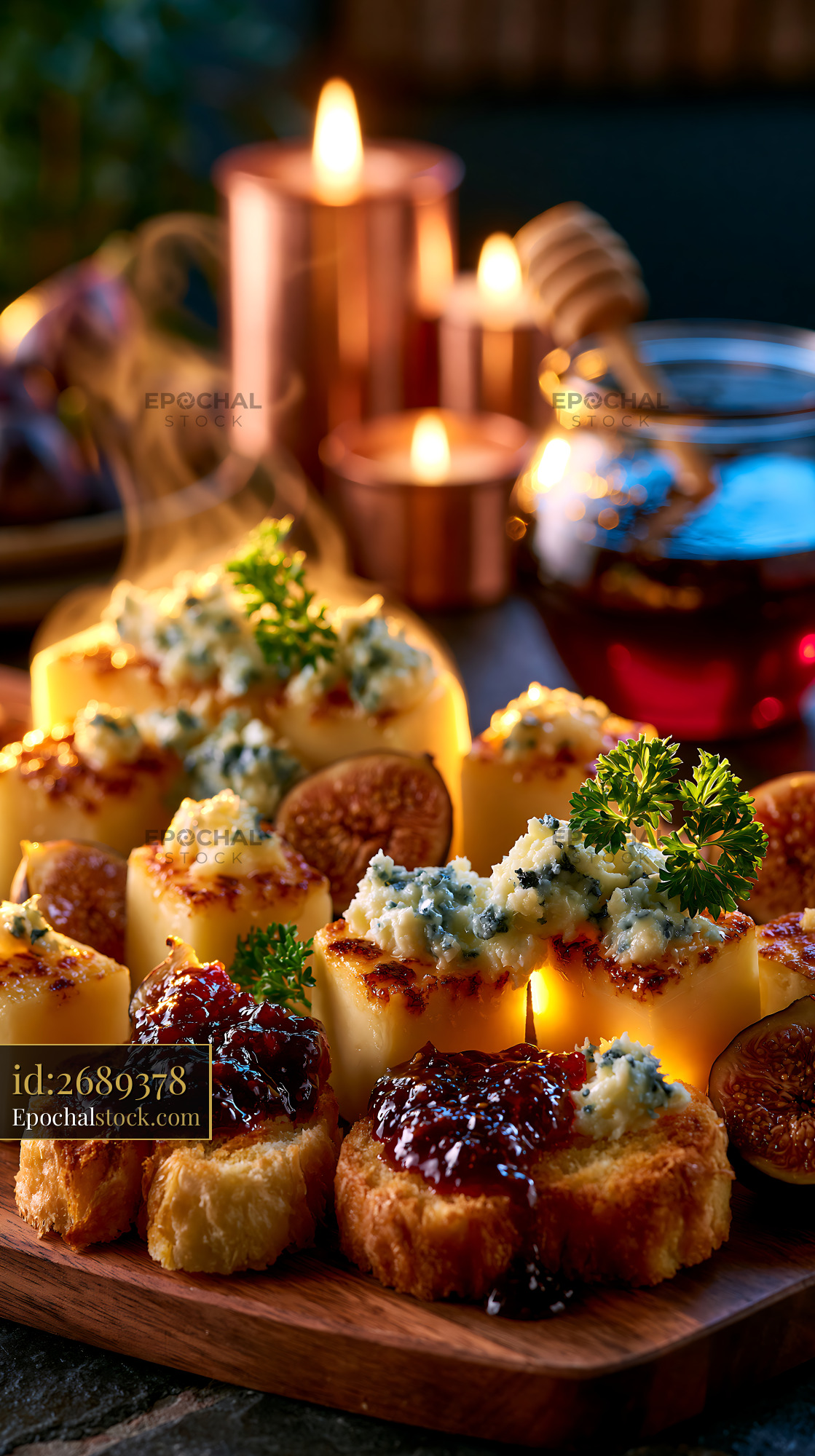 Watermarked full-resolution preview of Delicious appetizer platter with cheese, figs, and honey on a table