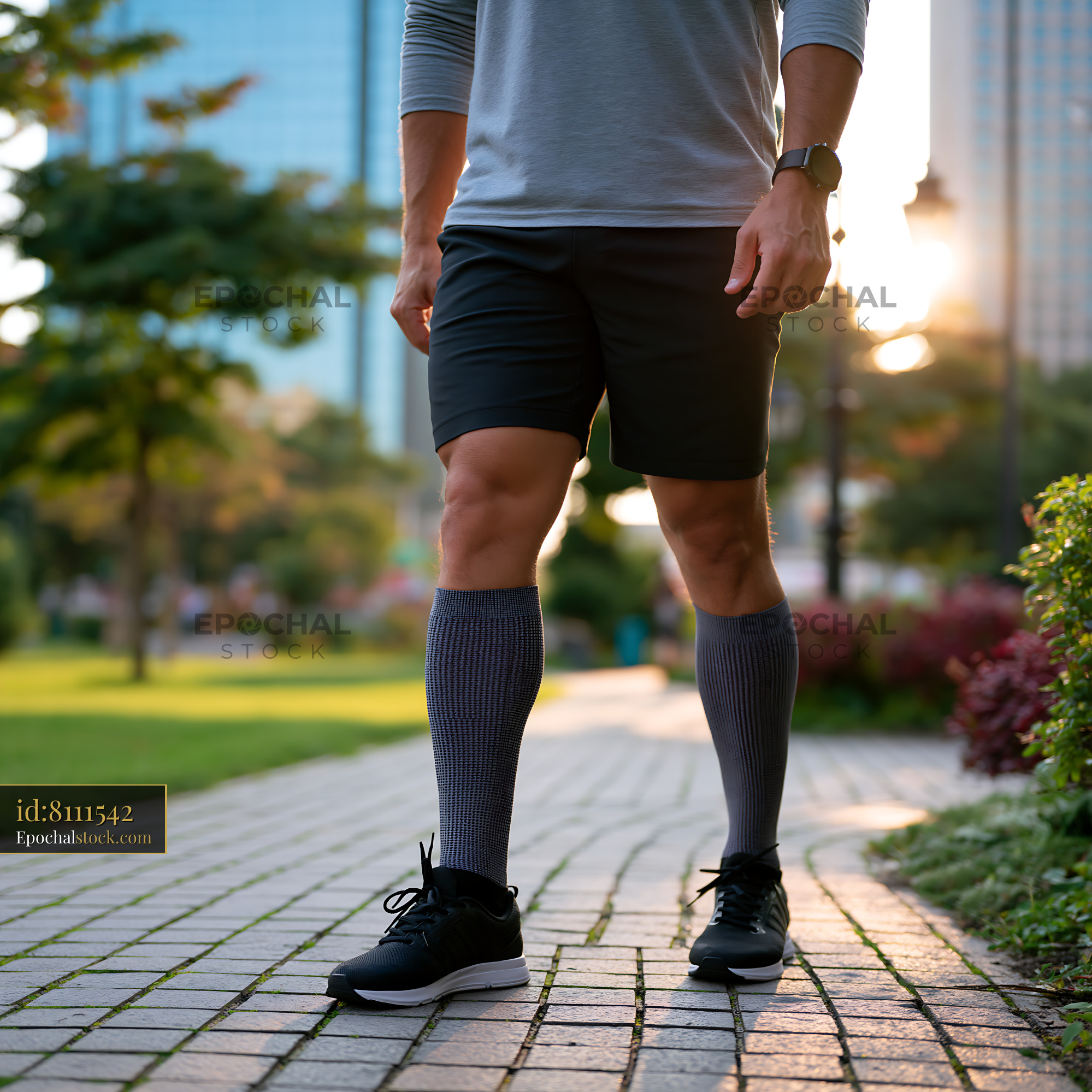 Watermarked full-resolution preview of Man walking in the park during sunset wearing athletic gear