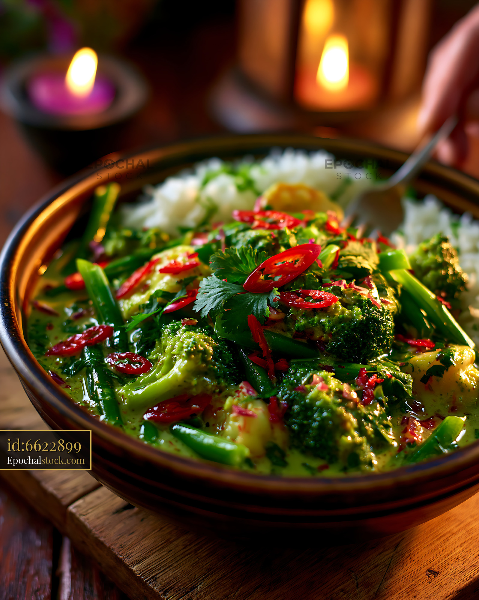 Watermarked full-resolution preview of Delicious green vegetable curry served with rice in a warm setting