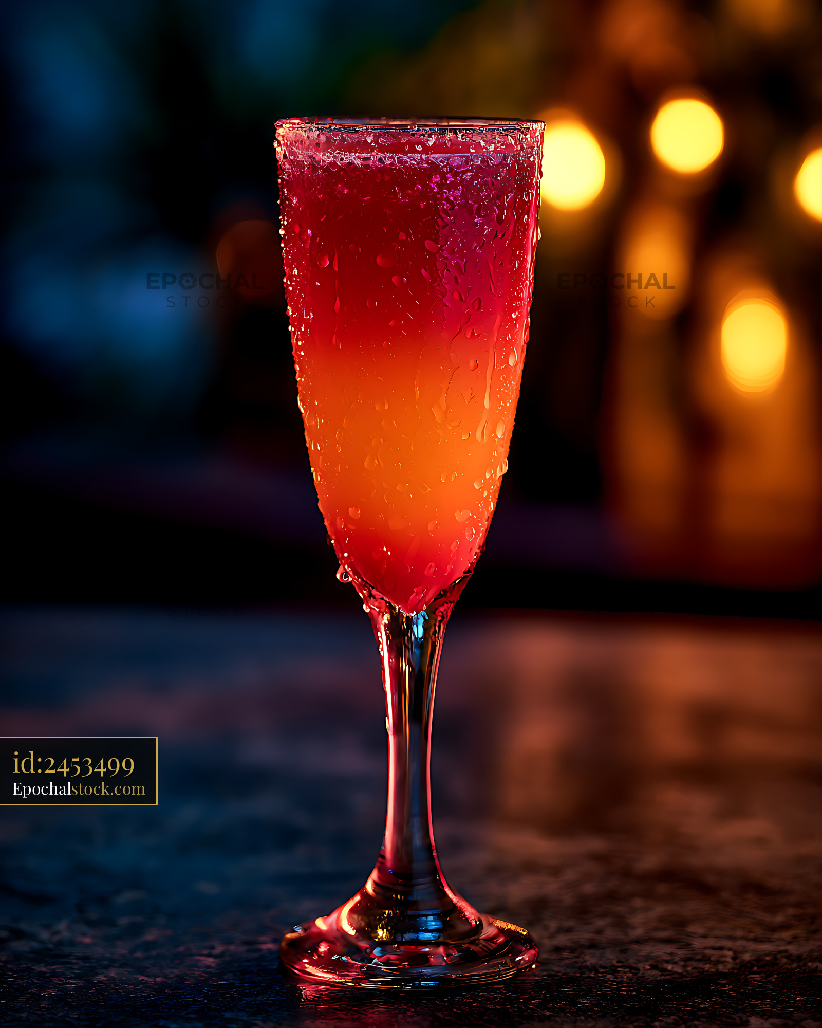 Watermarked full-resolution preview of Red-orange beverage in a chilled glass with colorful bokeh