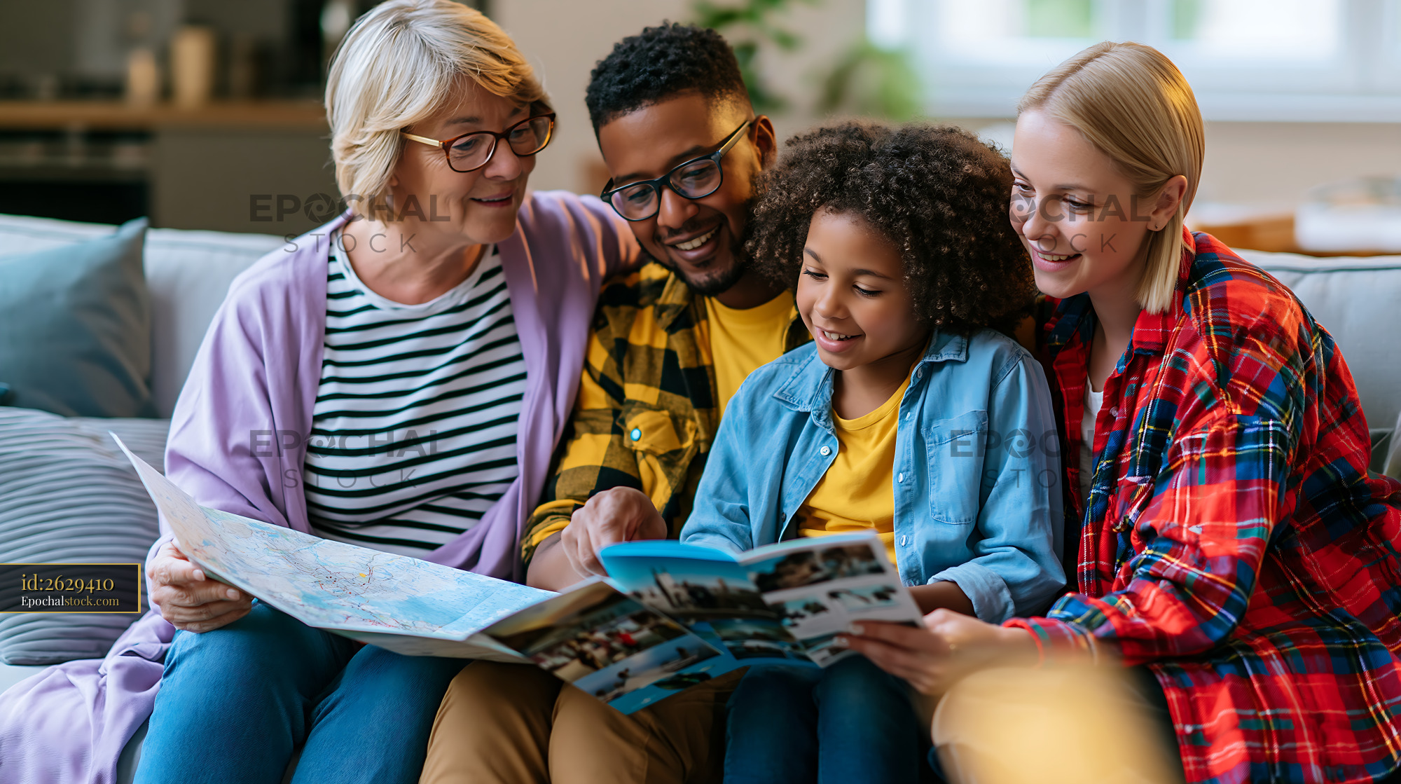Watermarked full-resolution preview of Family enjoying time together while reading a travel guide