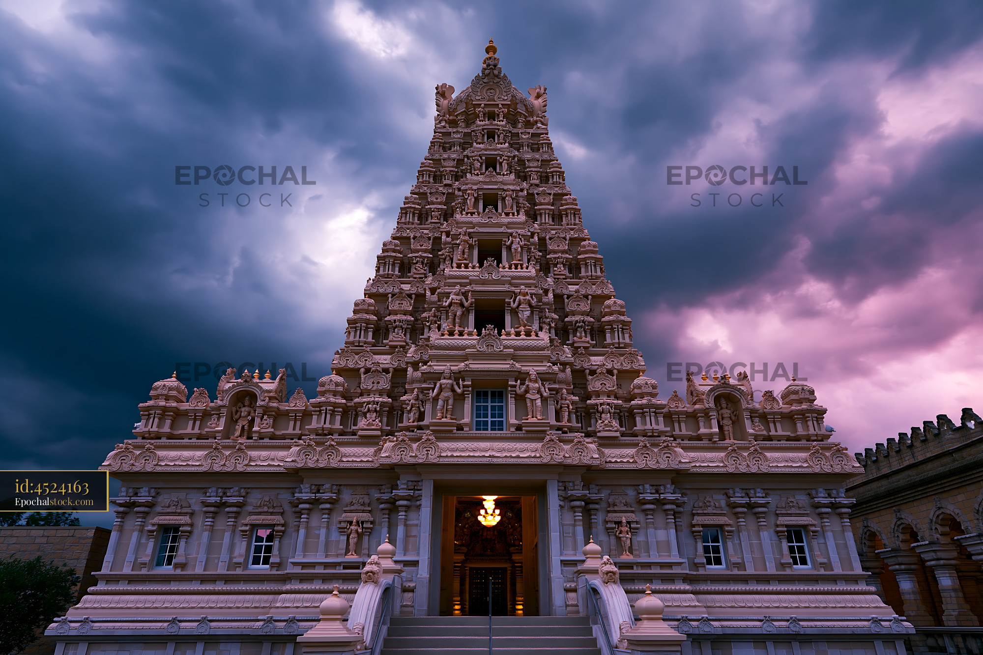 Watermarked full-resolution preview of Hindu temple under dramatic sky at dusk in India