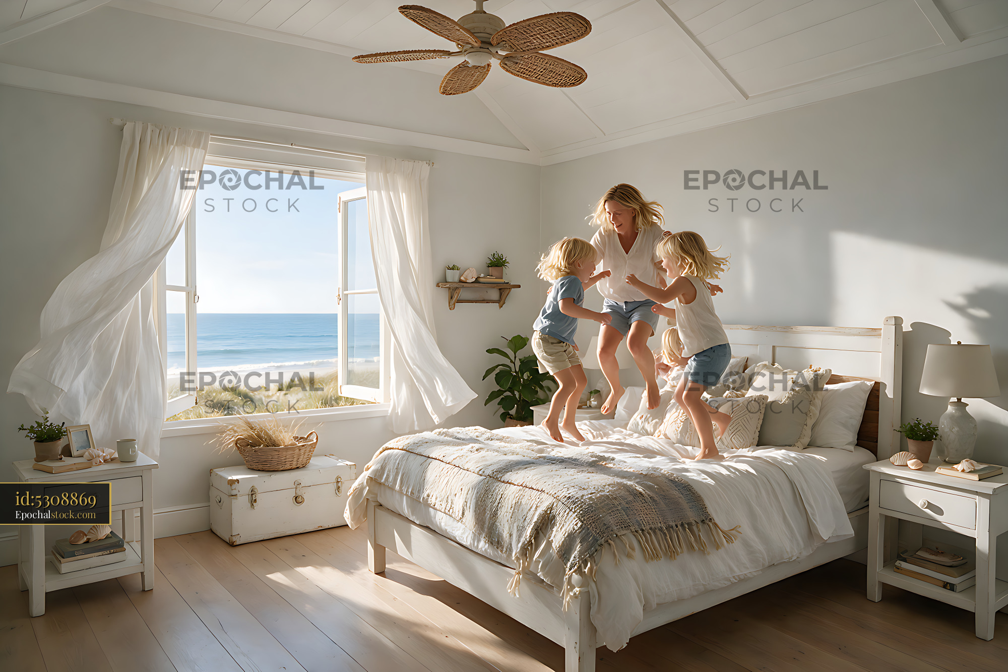 Watermarked full-resolution preview of Mother and two blond children jumping on a bed