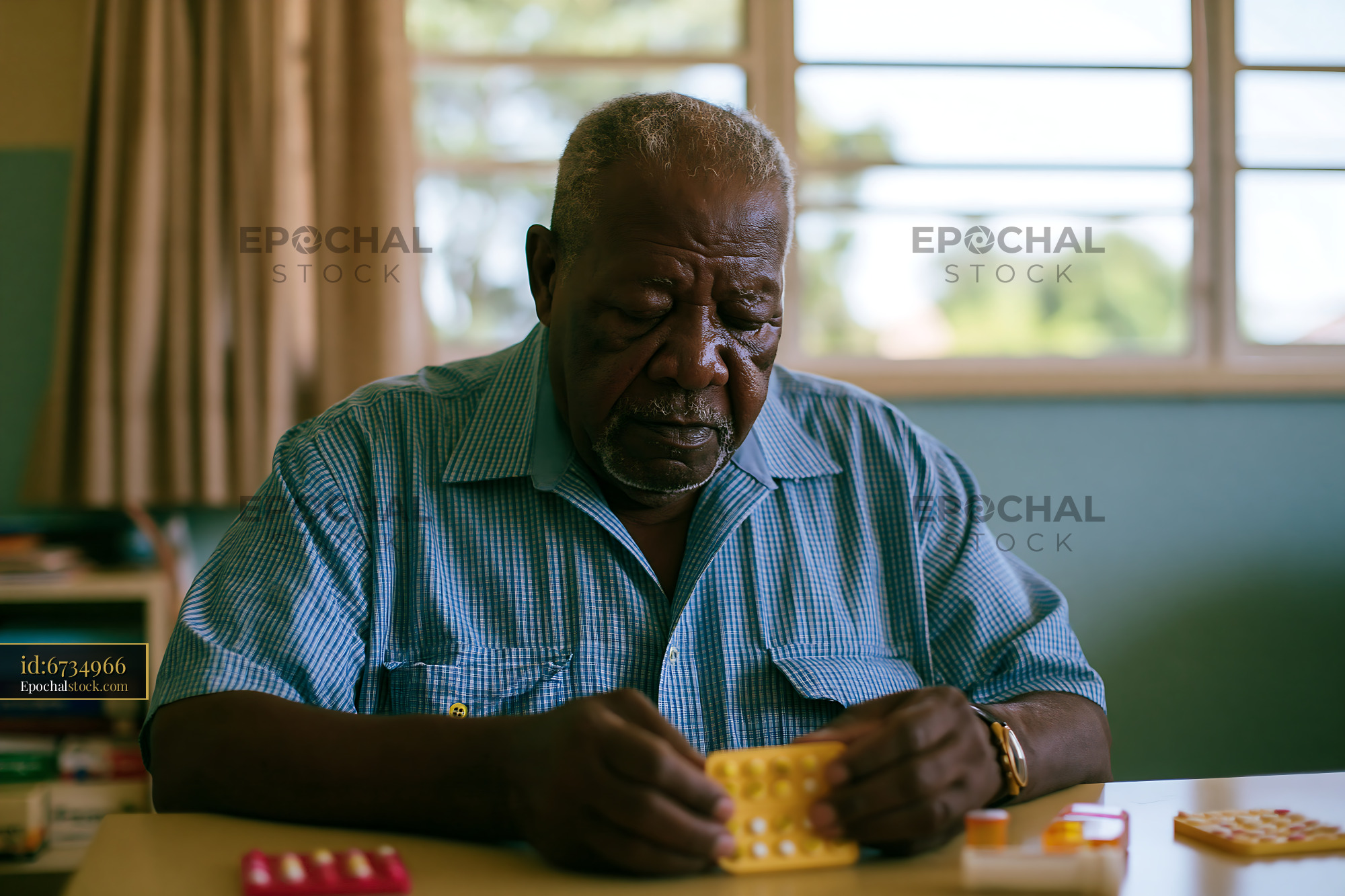 Watermarked full-resolution preview of Elderly man working on a puzzle at a table indoors