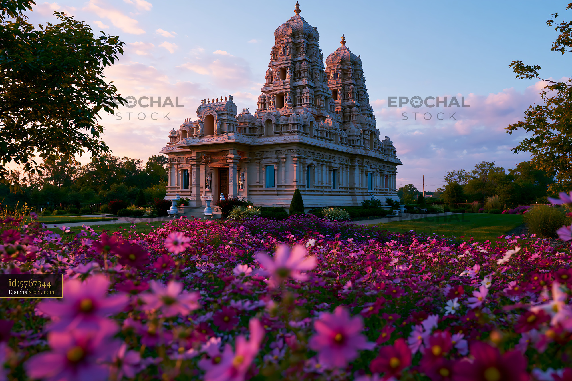 BAPS Shri Swaminarayan Mandir in Brightly Colored Flower Garden - stock photo