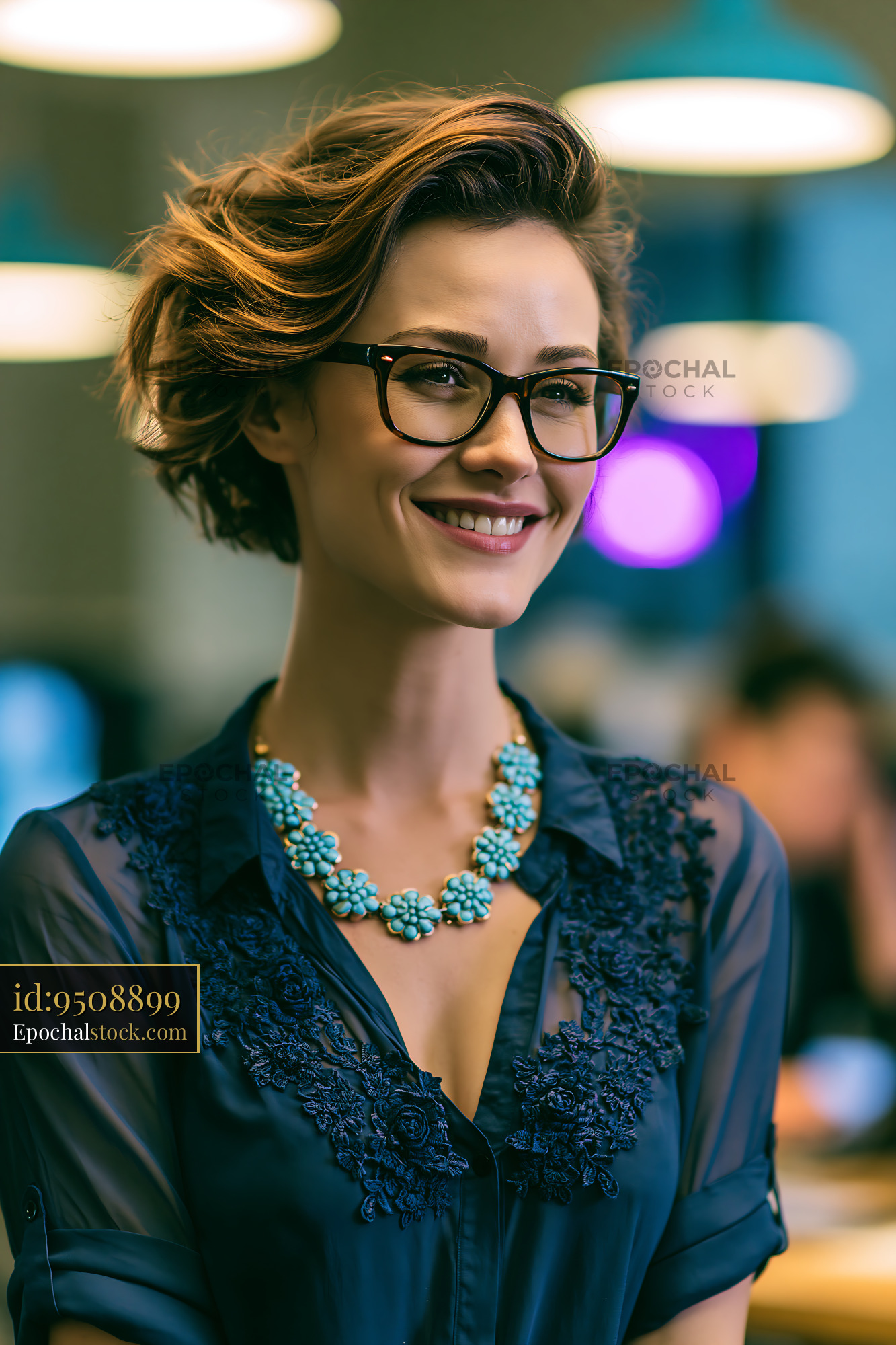 Watermarked full-resolution preview of Woman with glasses and necklace smiling in modern office