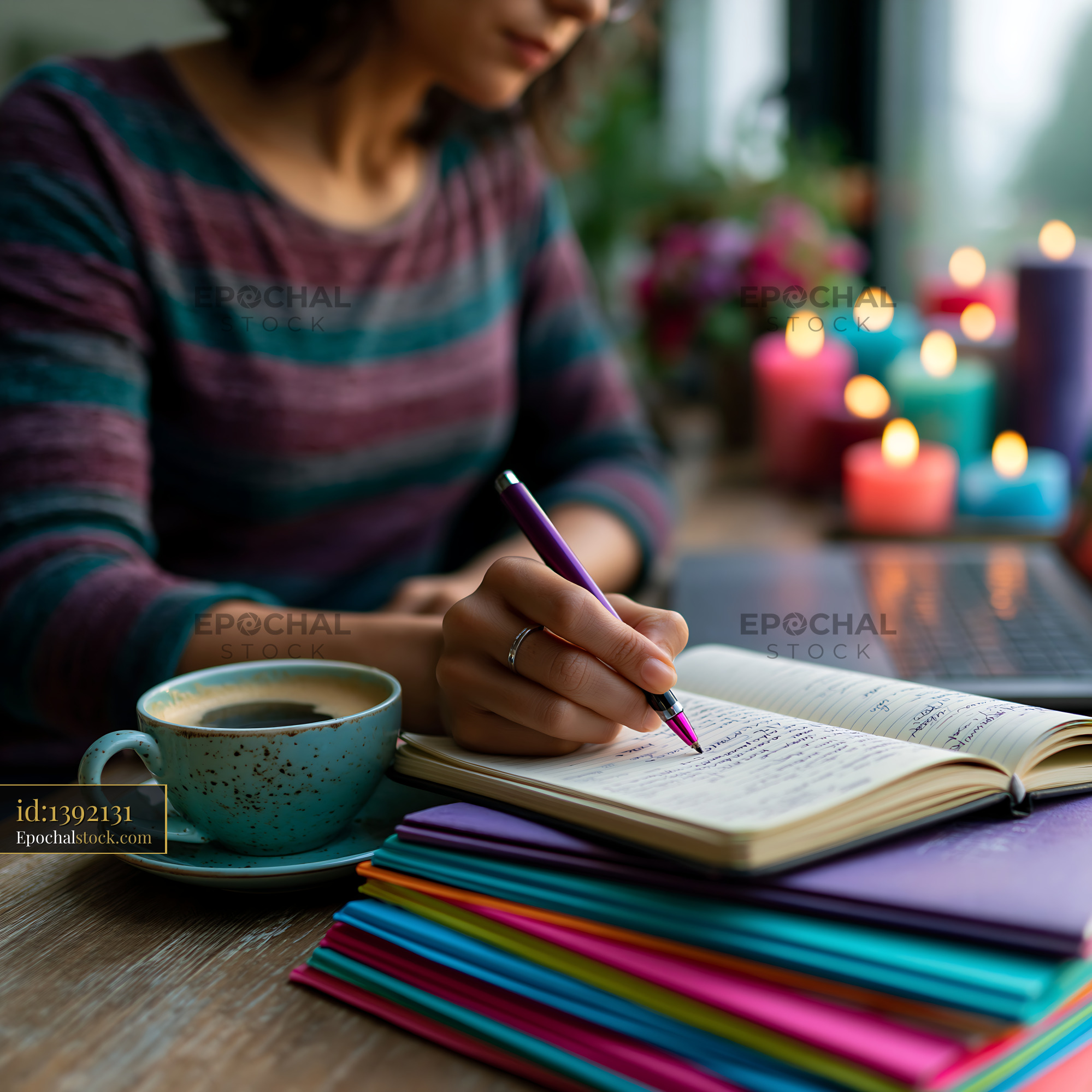Watermarked full-resolution preview of Person writing in a notebook with coffee and colorful papers