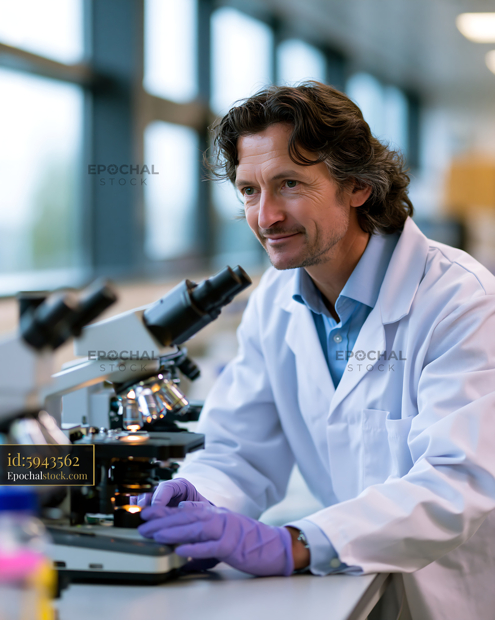 Watermarked full-resolution preview of Scientist working in laboratory with microscope