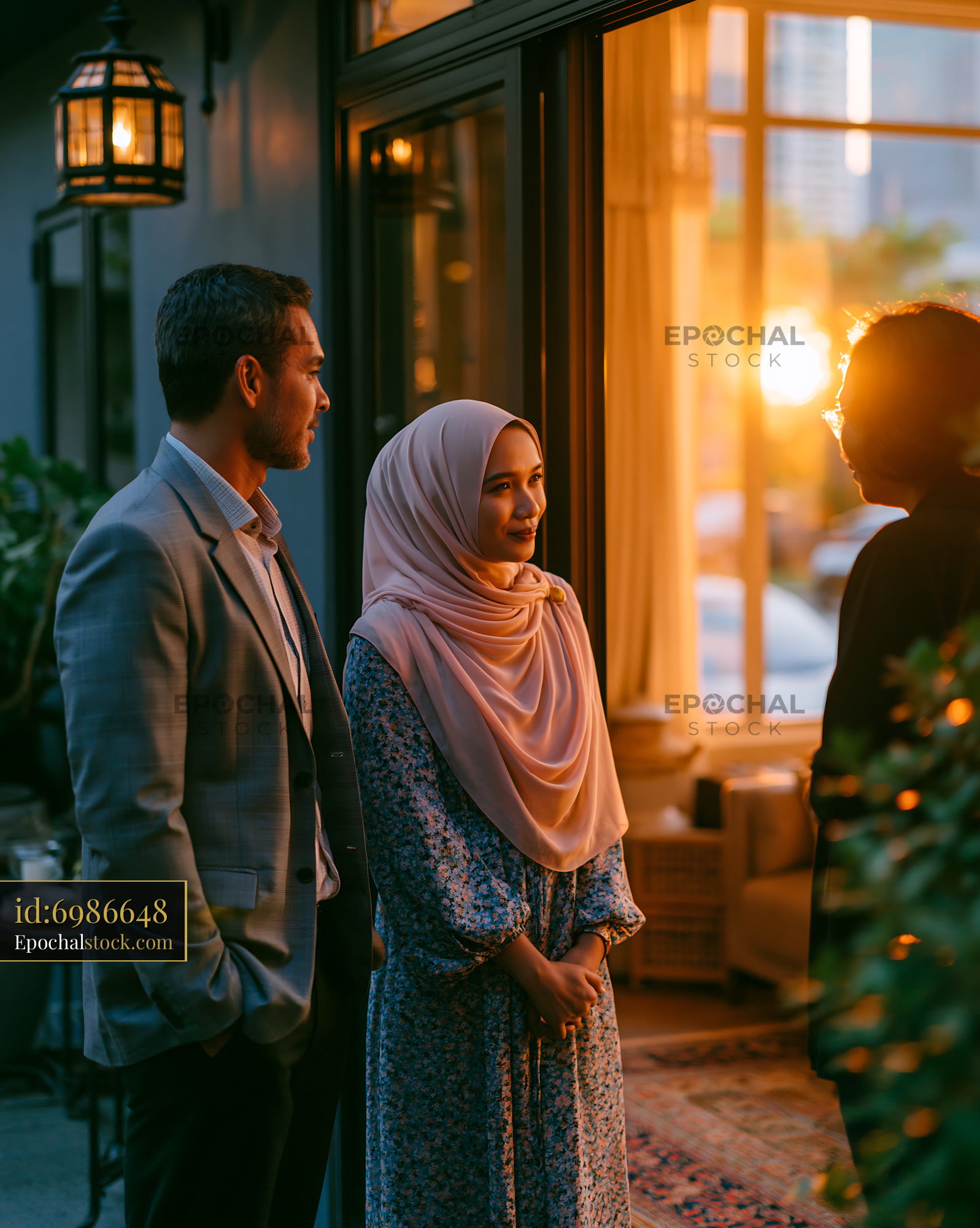 Watermarked full-resolution preview of People talking during sunset by a cafe with warm light