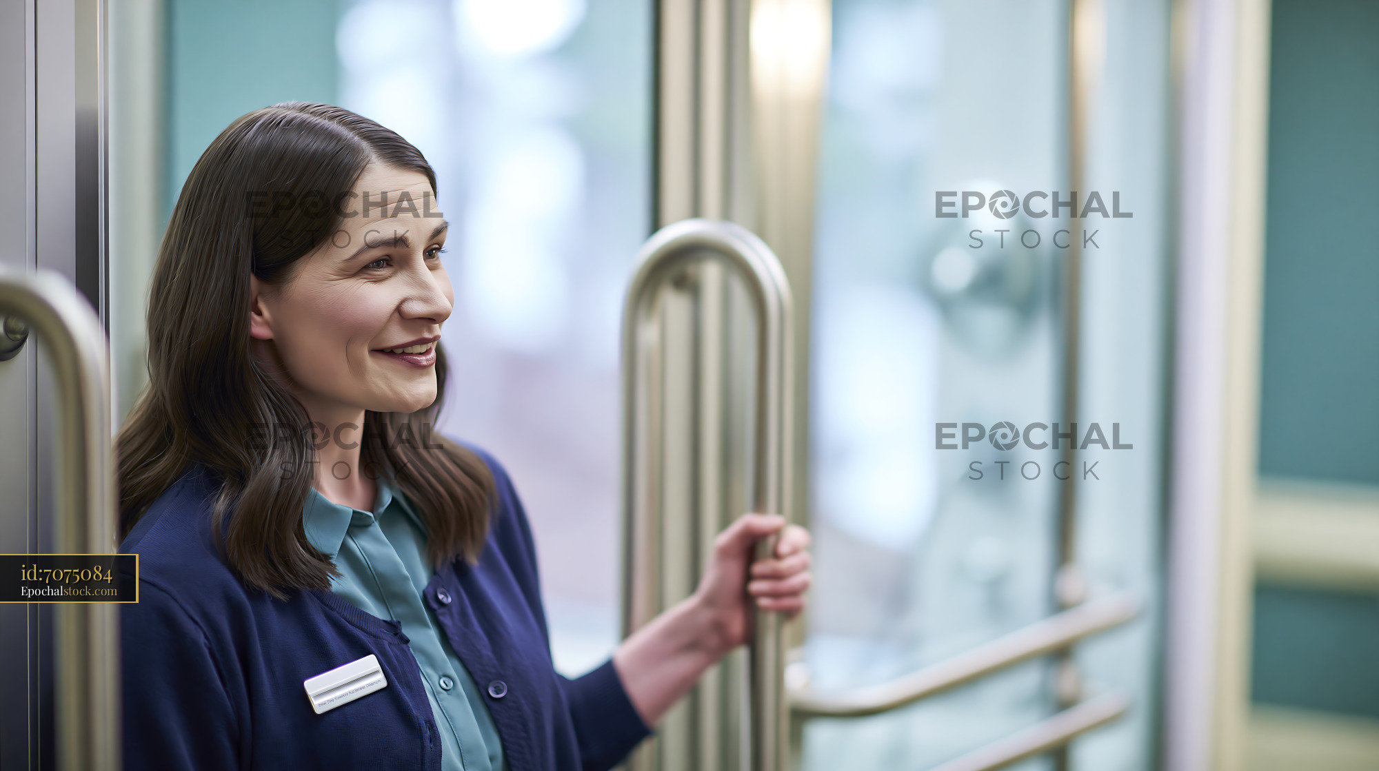 Watermarked full-resolution preview of Smiling woman in a modern elevator