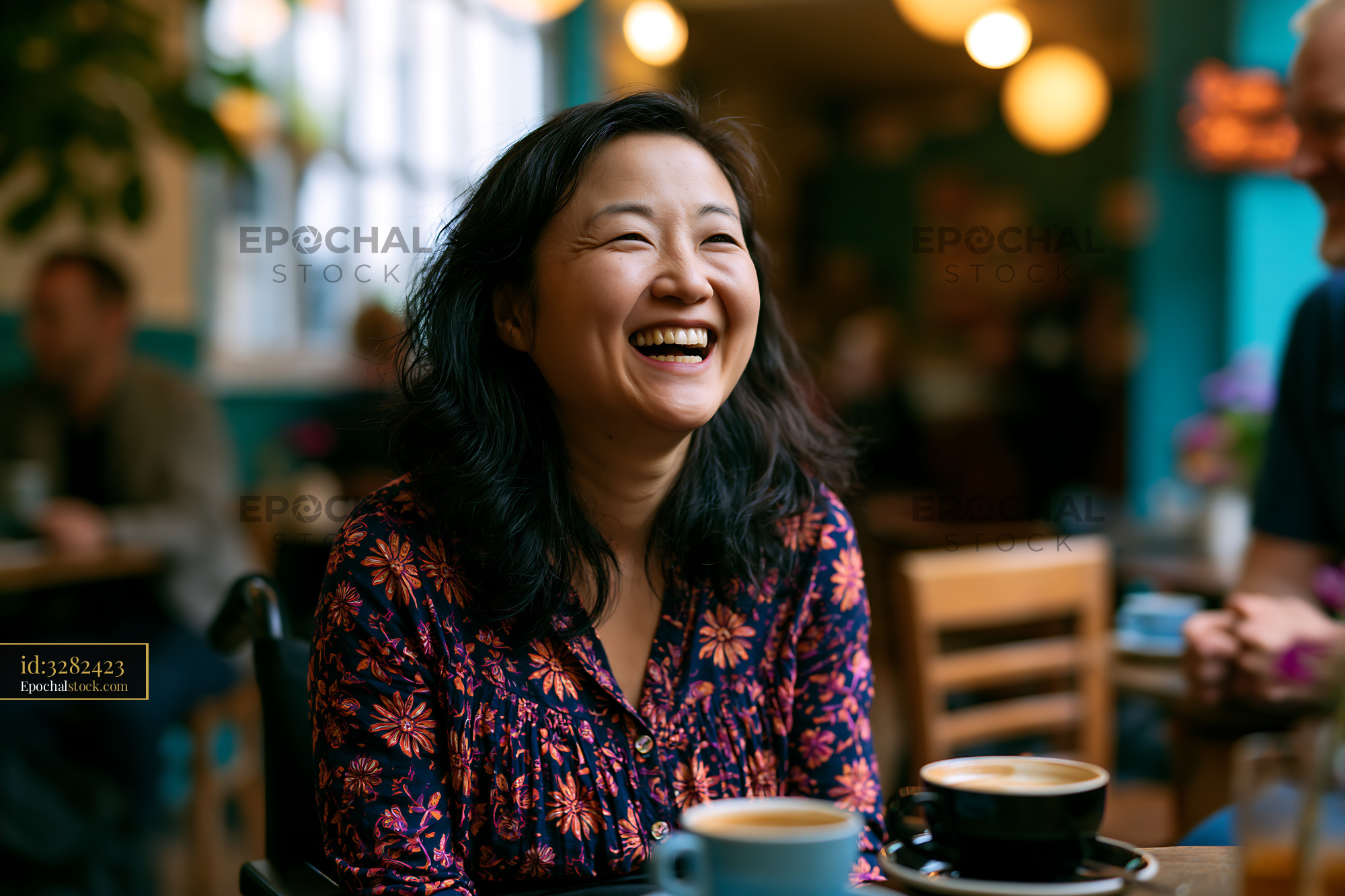 Watermarked full-resolution preview of Woman laughing in a cafe while enjoying coffee with friends