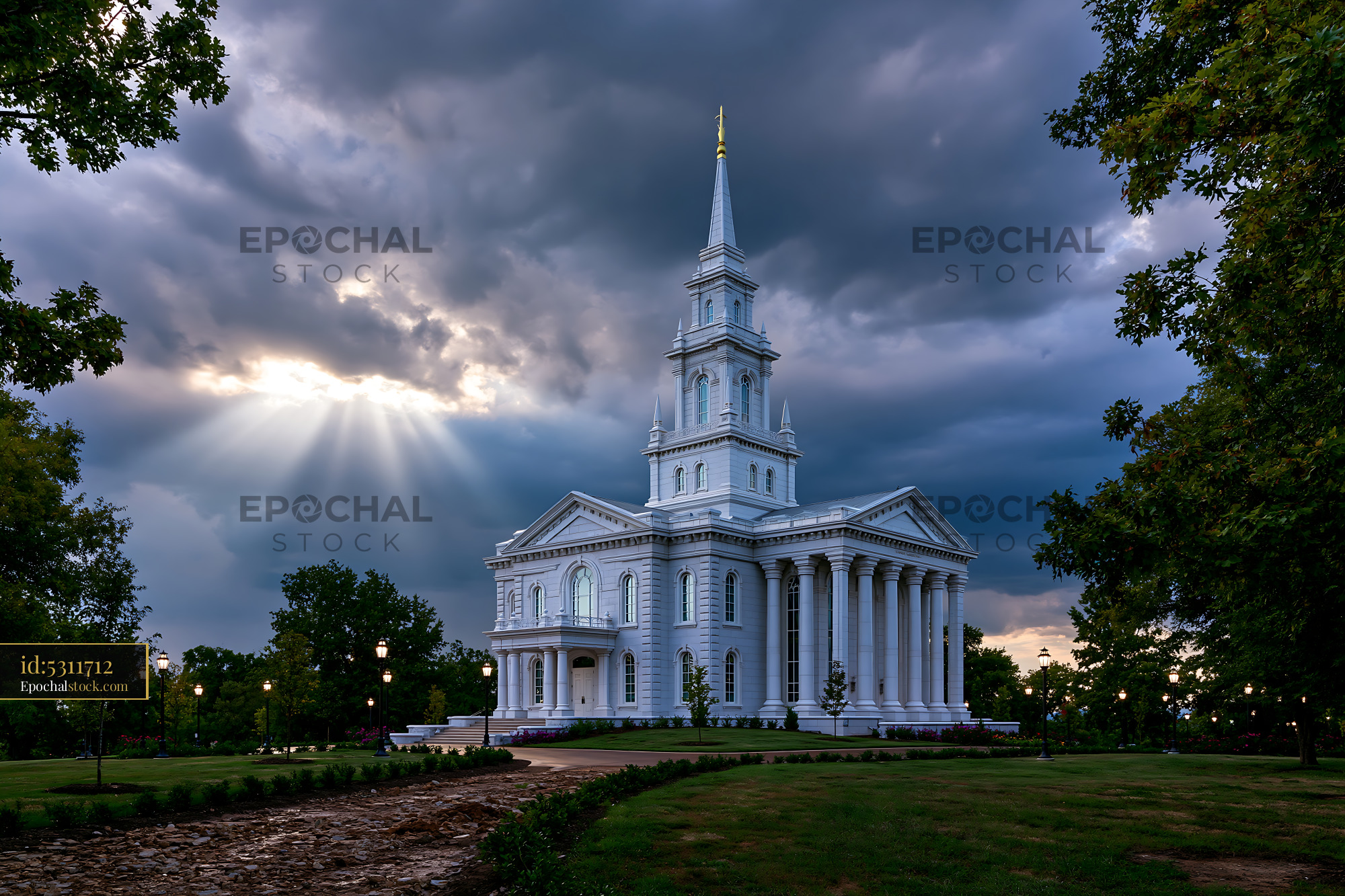 Watermarked full-resolution preview of White church building under cloudy sky with sunlight beams