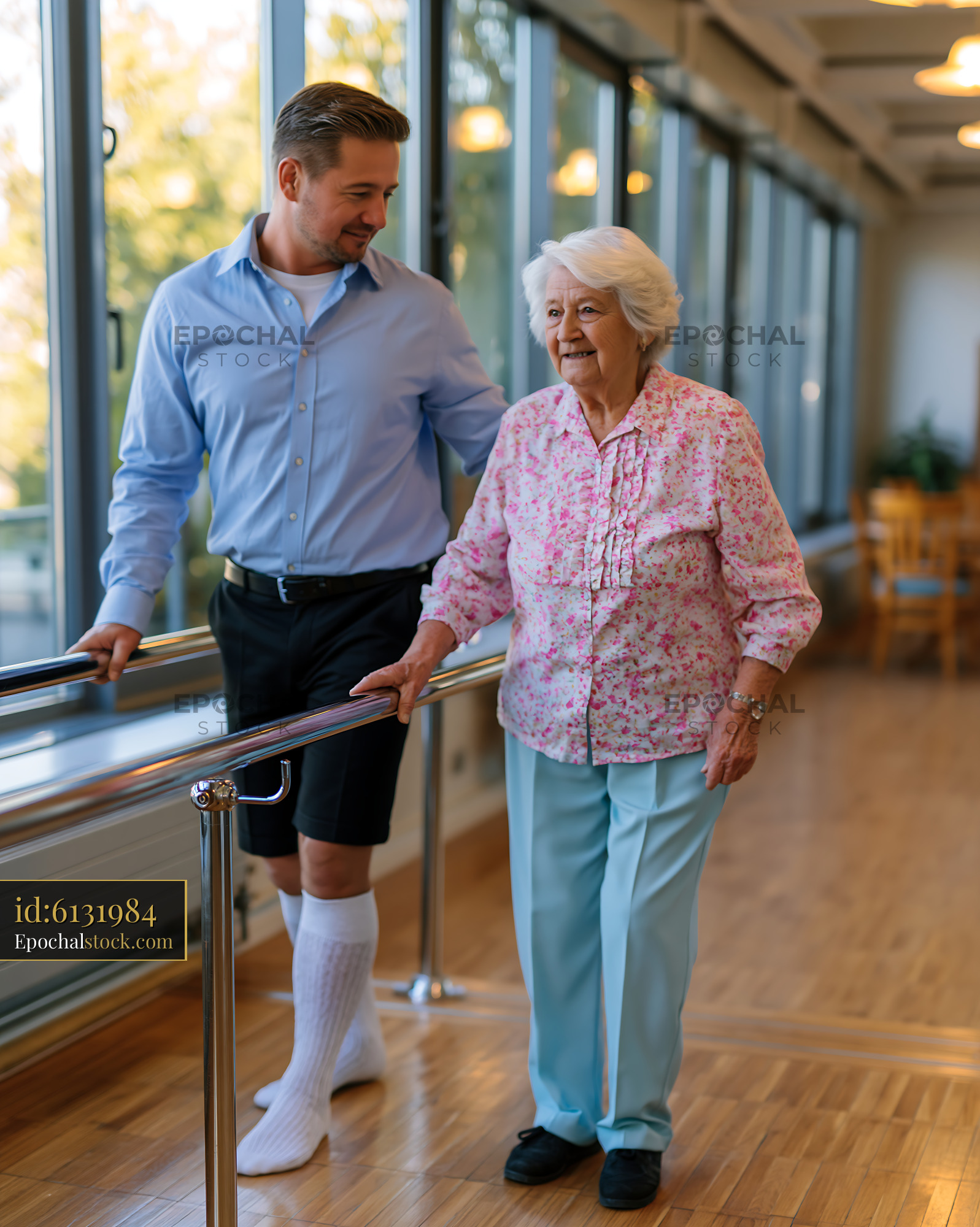 Watermarked full-resolution preview of Man assisting senior woman in walking practice indoors
