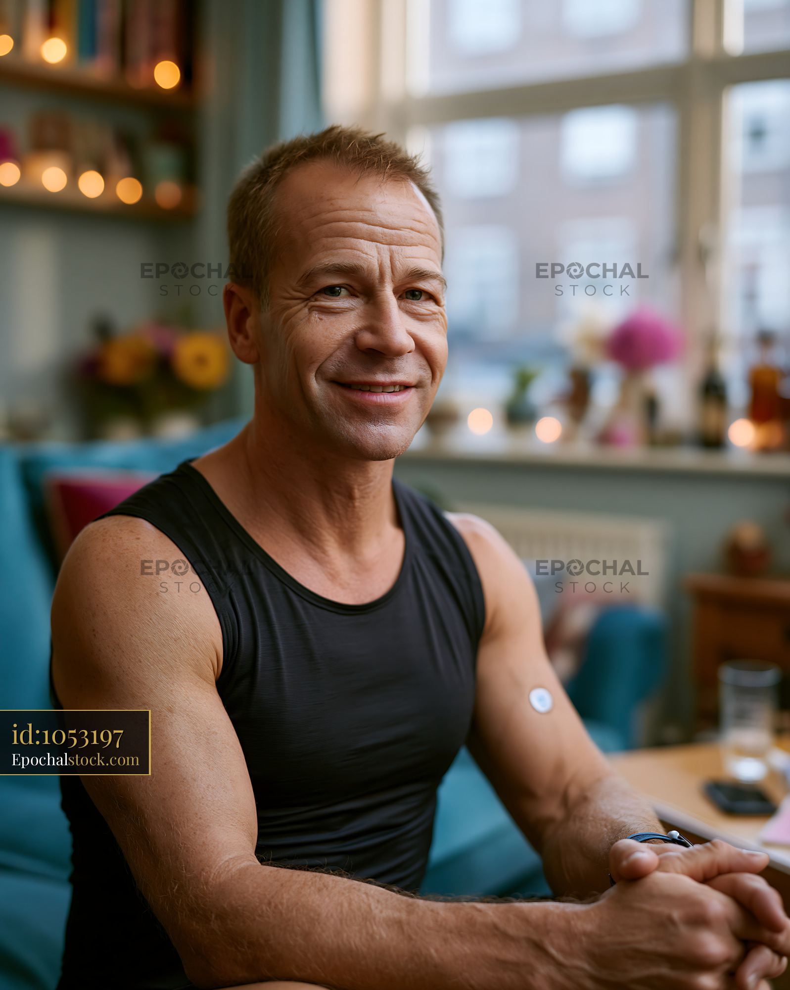 Watermarked full-resolution preview of Friendly smiling man in a softly lit cafe interior