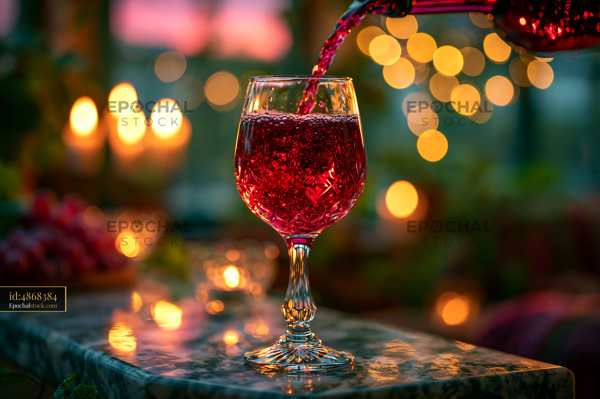 Watermarked full-resolution preview of Red beverage in glass with warm lights in the background