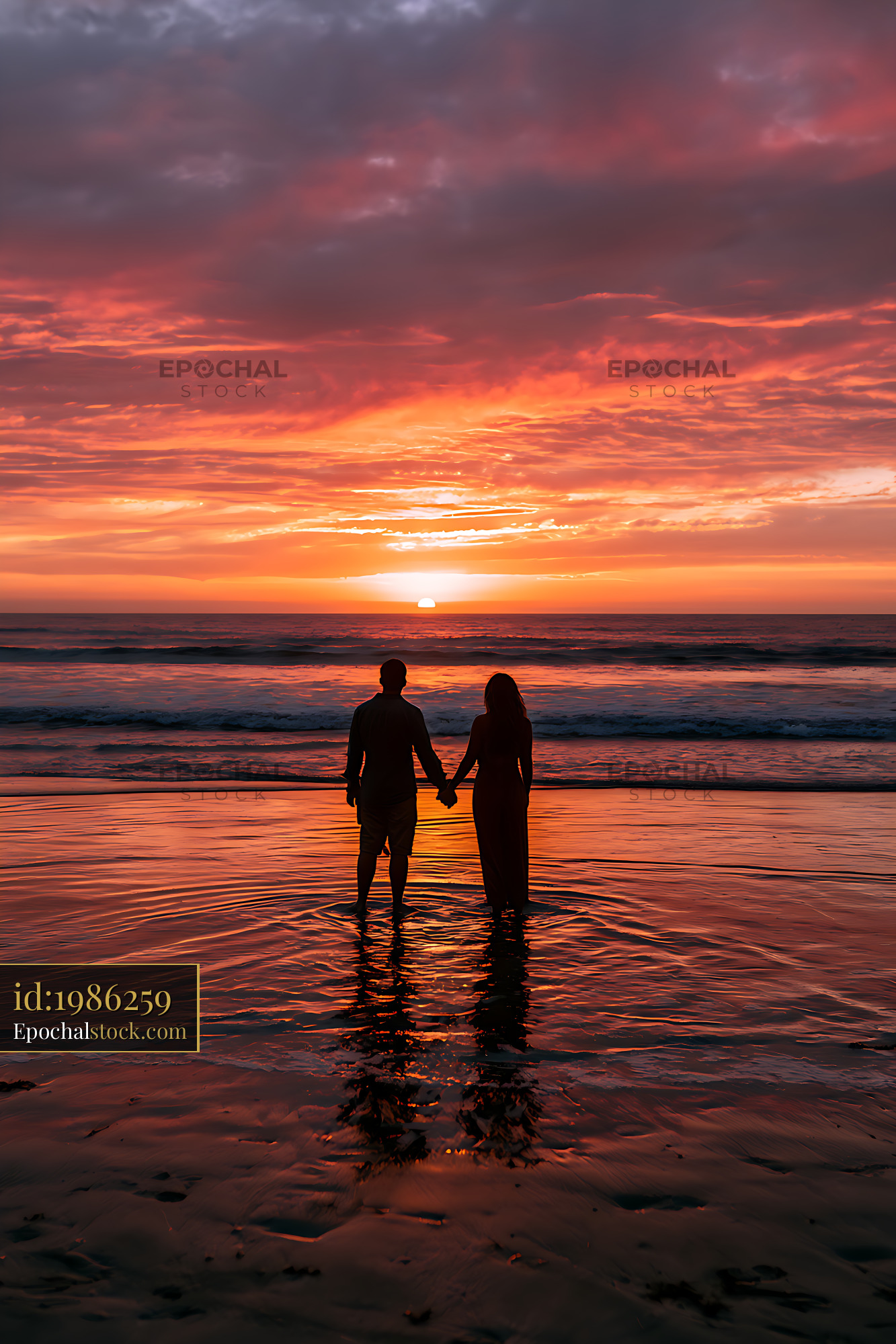 Watermarked full-resolution preview of Silhouetted couple standing in shallow water at sunset