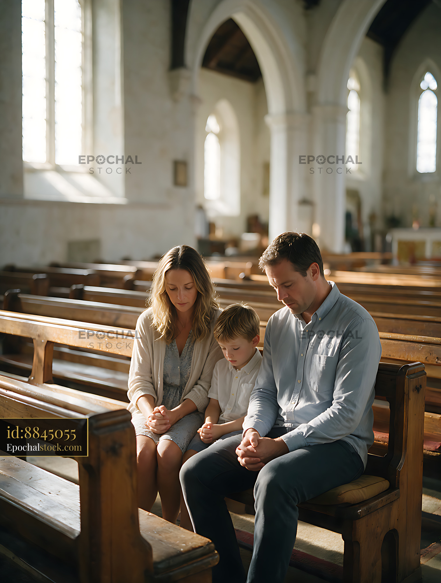 Watermarked full-resolution preview of Family of three praying in a church pew