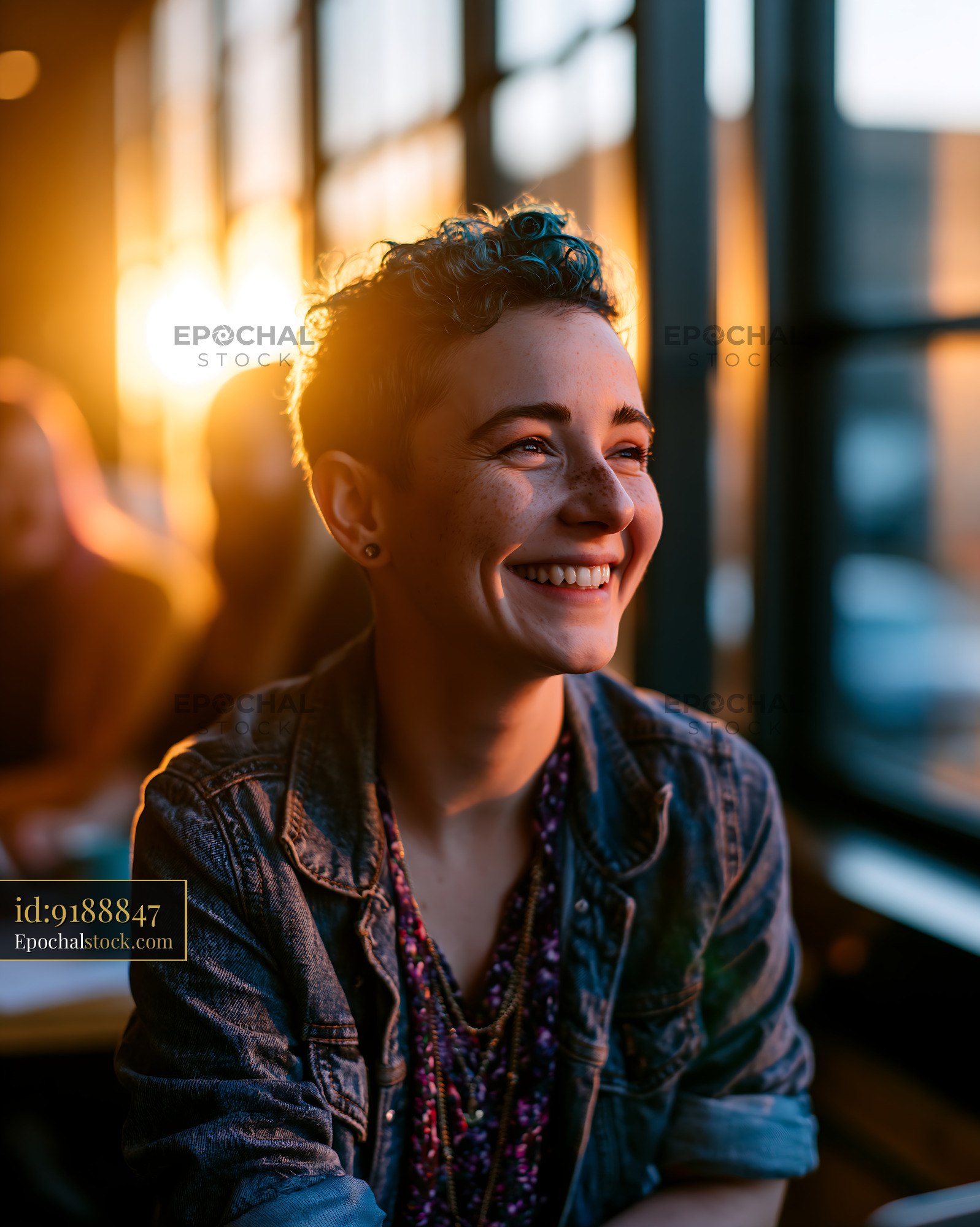 Watermarked full-resolution preview of Smiling person with short hair in a cafe during sunset