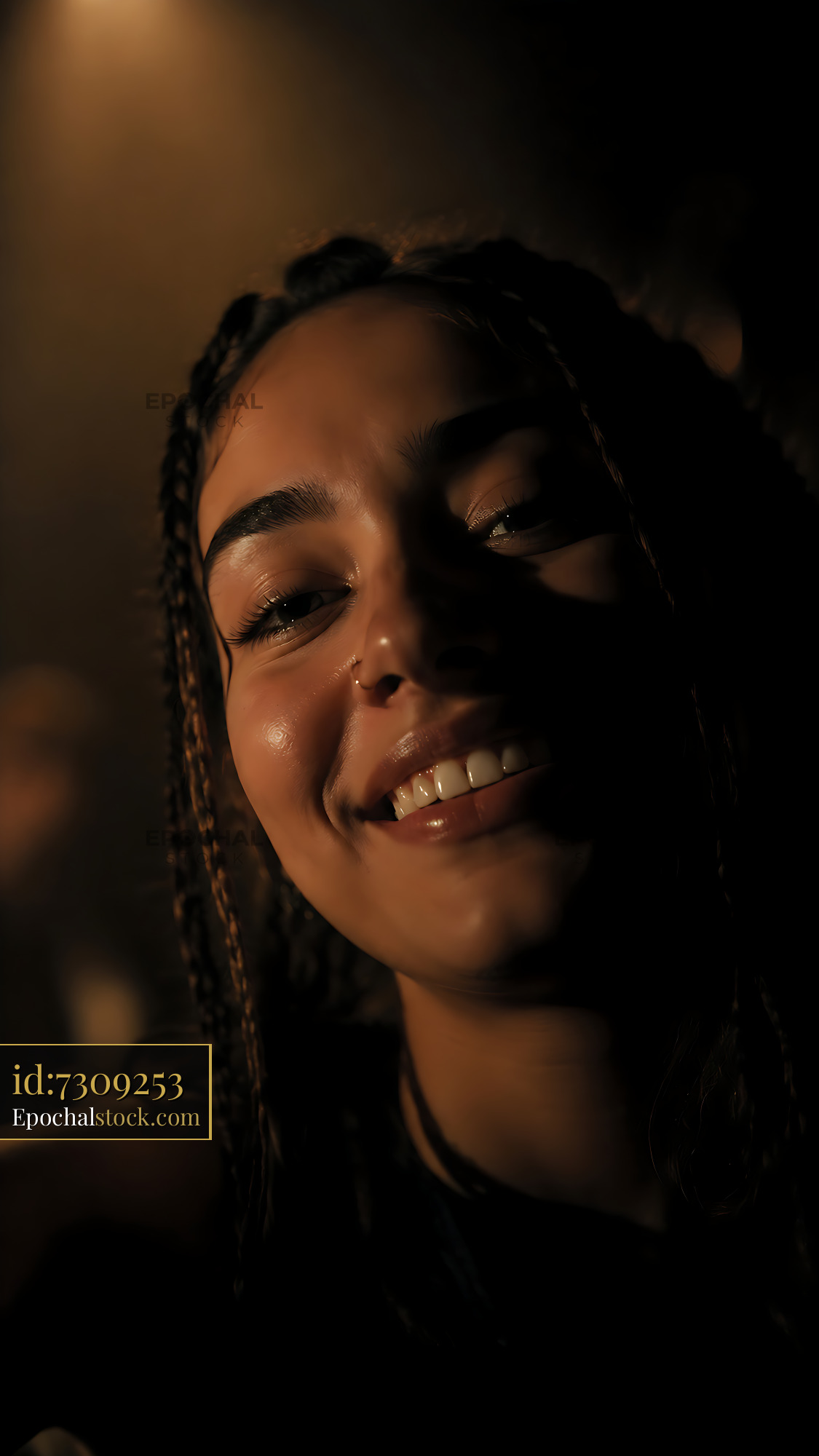 Woman Smiling Under Warm Light in Indoor Gathering Space - stock photo