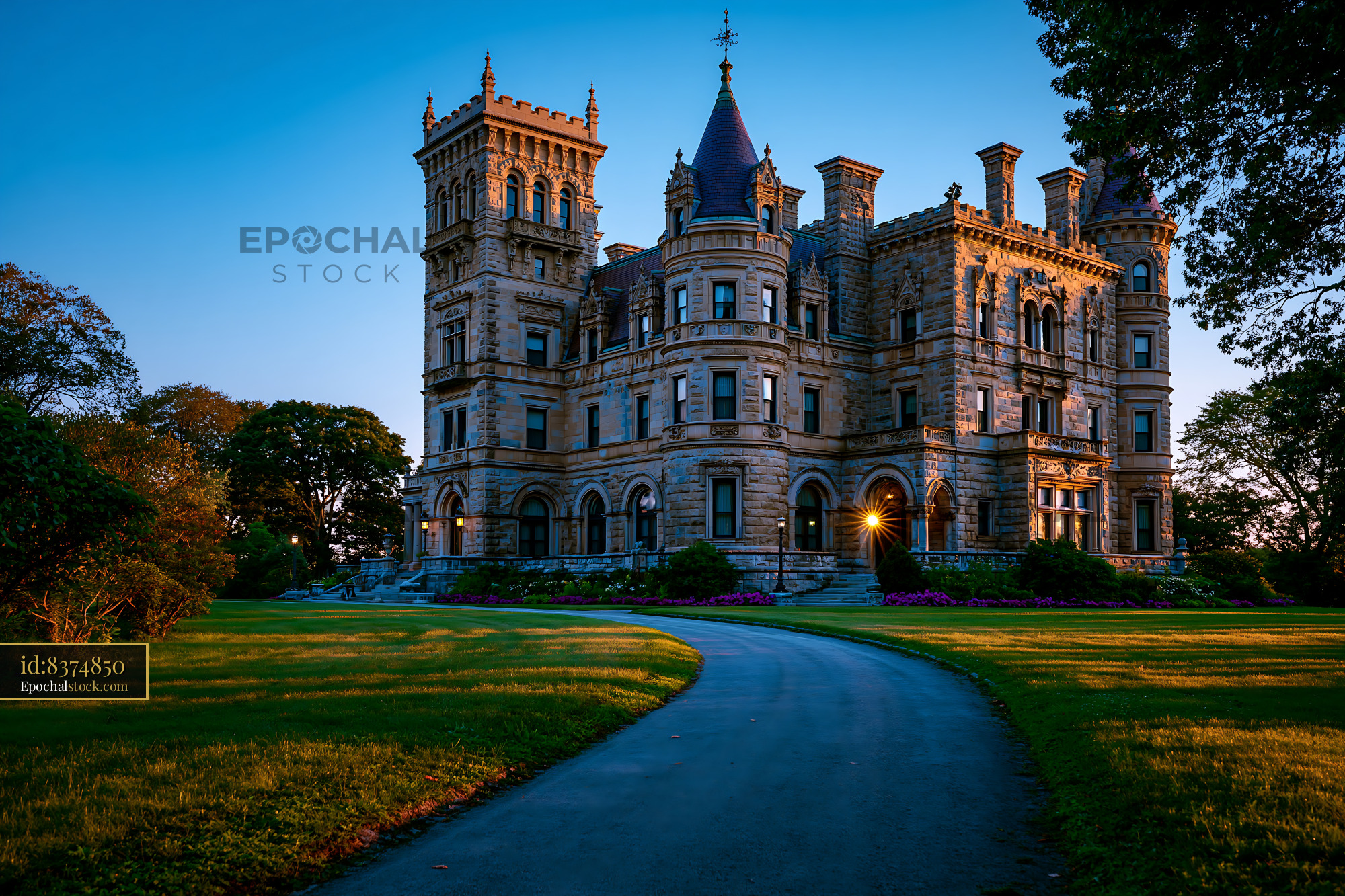 Watermarked full-resolution preview of Historic mansion with stone facade and large windows at sunset