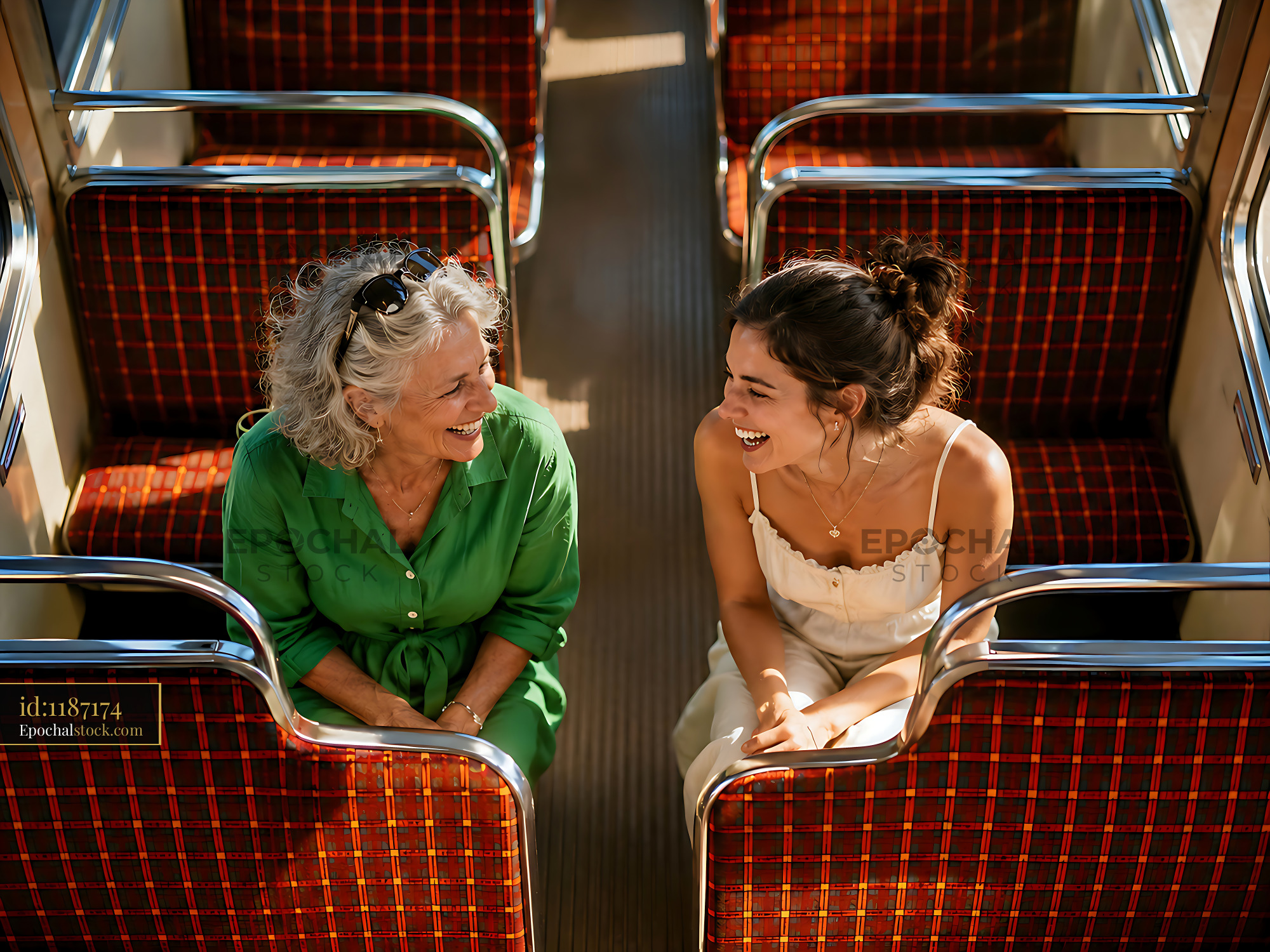 Watermarked full-resolution preview of Two women sharing a laugh on a public transport seat