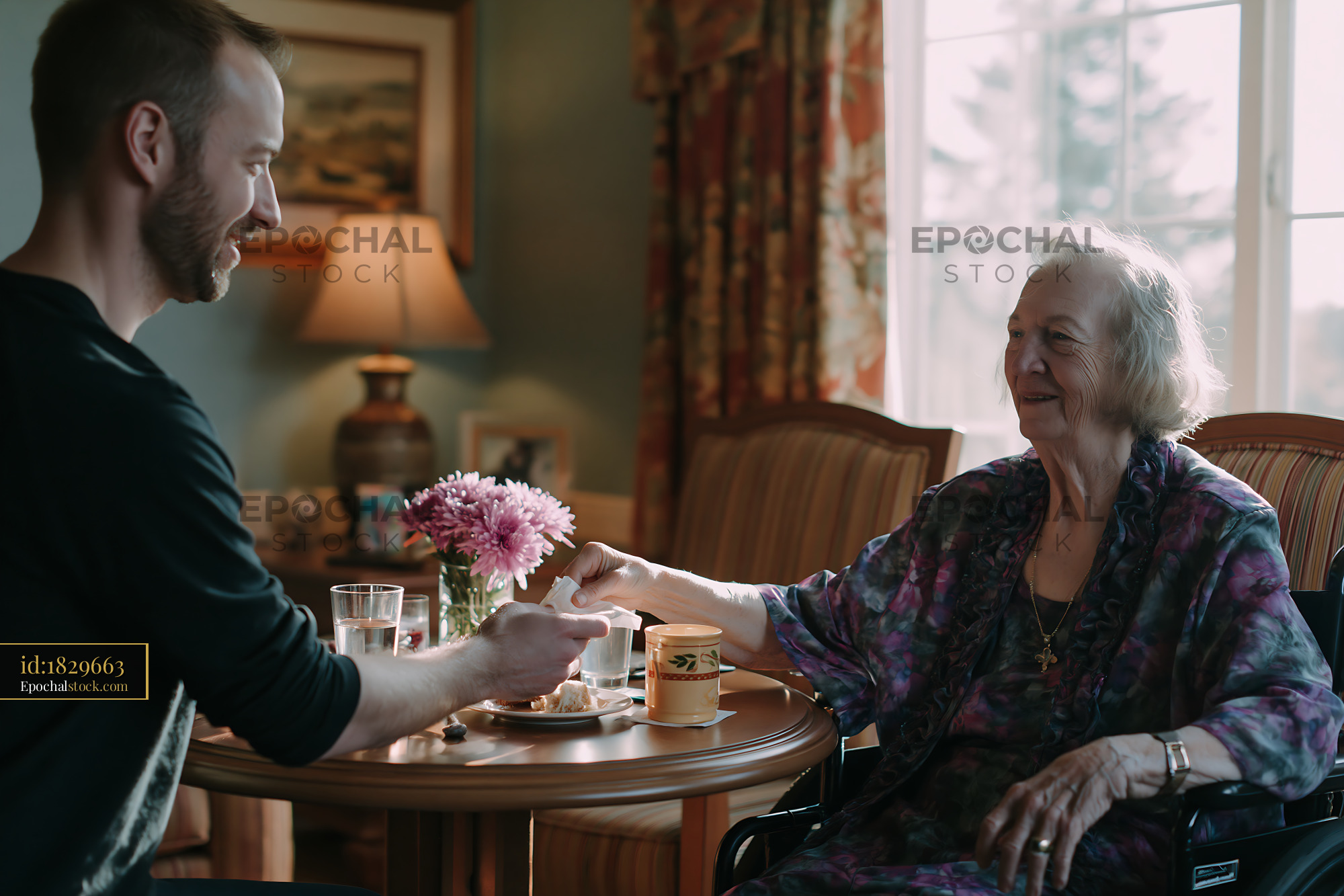 Watermarked full-resolution preview of Caregiver assisting senior woman during tea at home