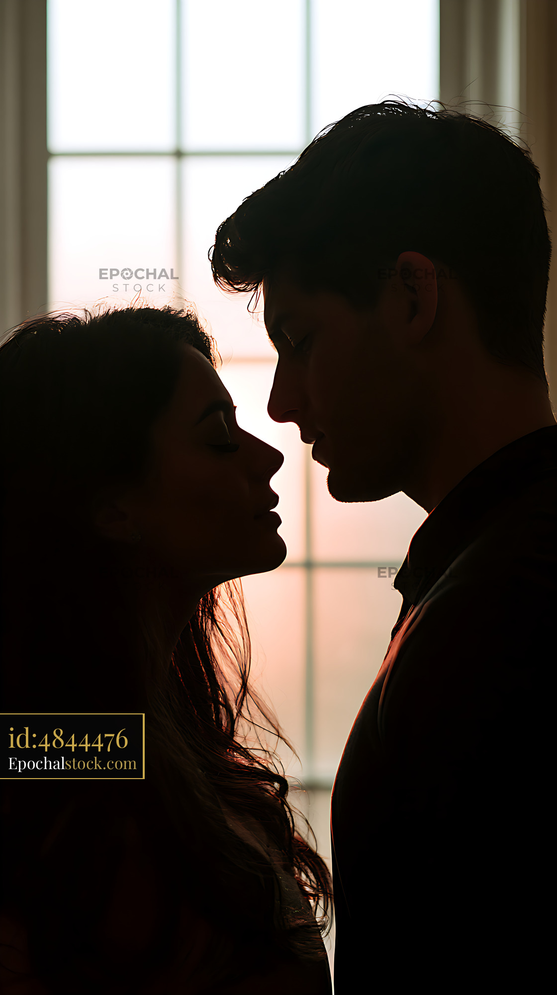 Watermarked full-resolution preview of Romantic silhouette of a couple near a bright window