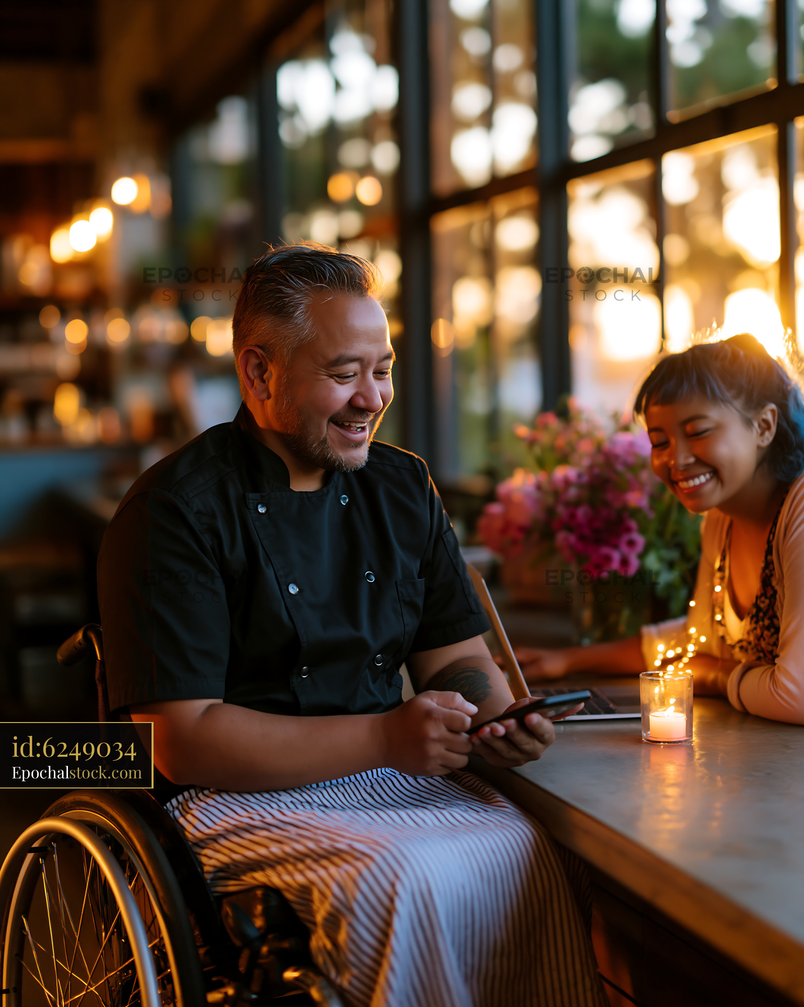 Watermarked full-resolution preview of Chef in wheelchair smiles while talking with a guest at sunset