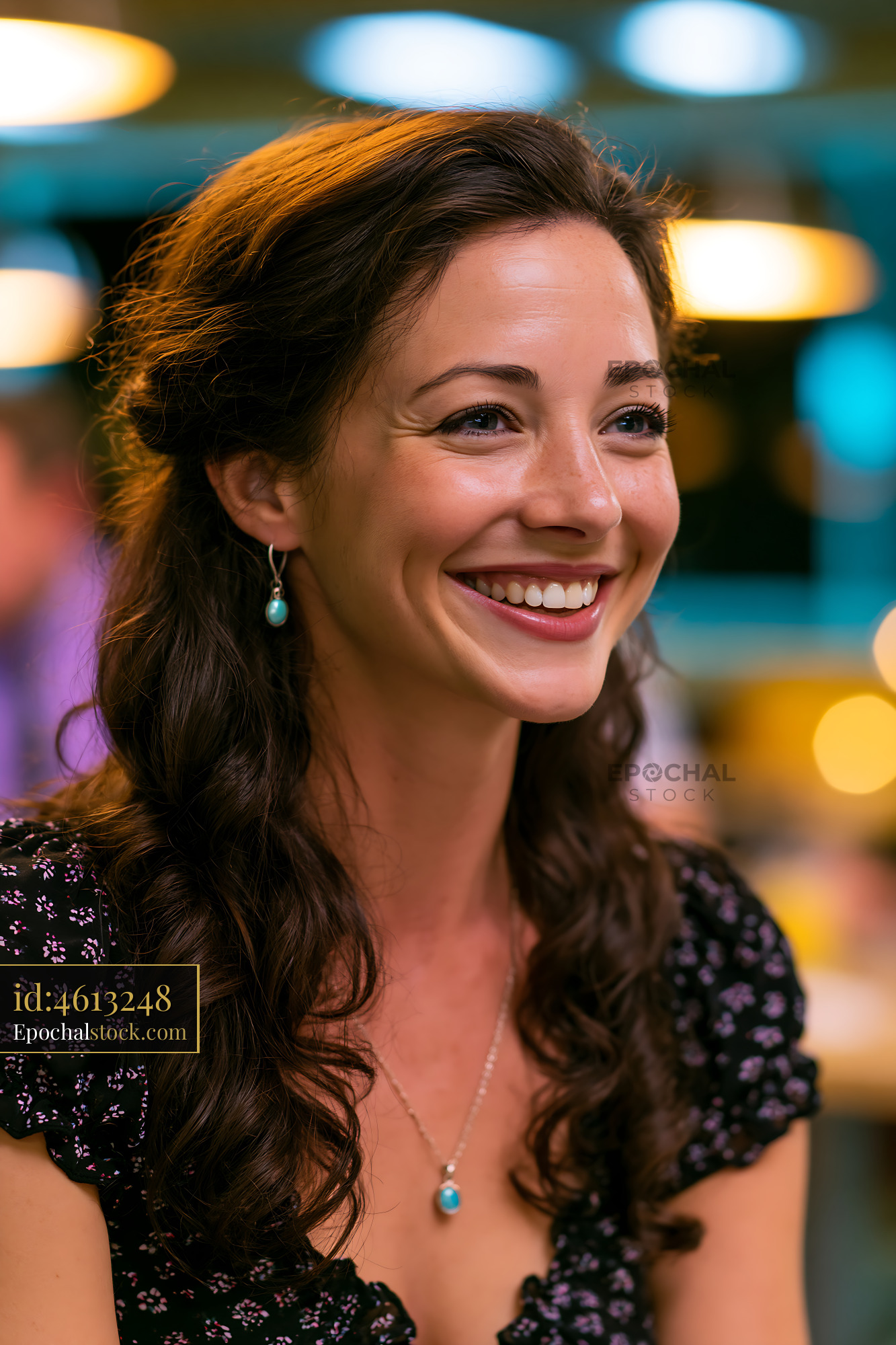 Watermarked full-resolution preview of Woman smiling at social gathering inside a bar