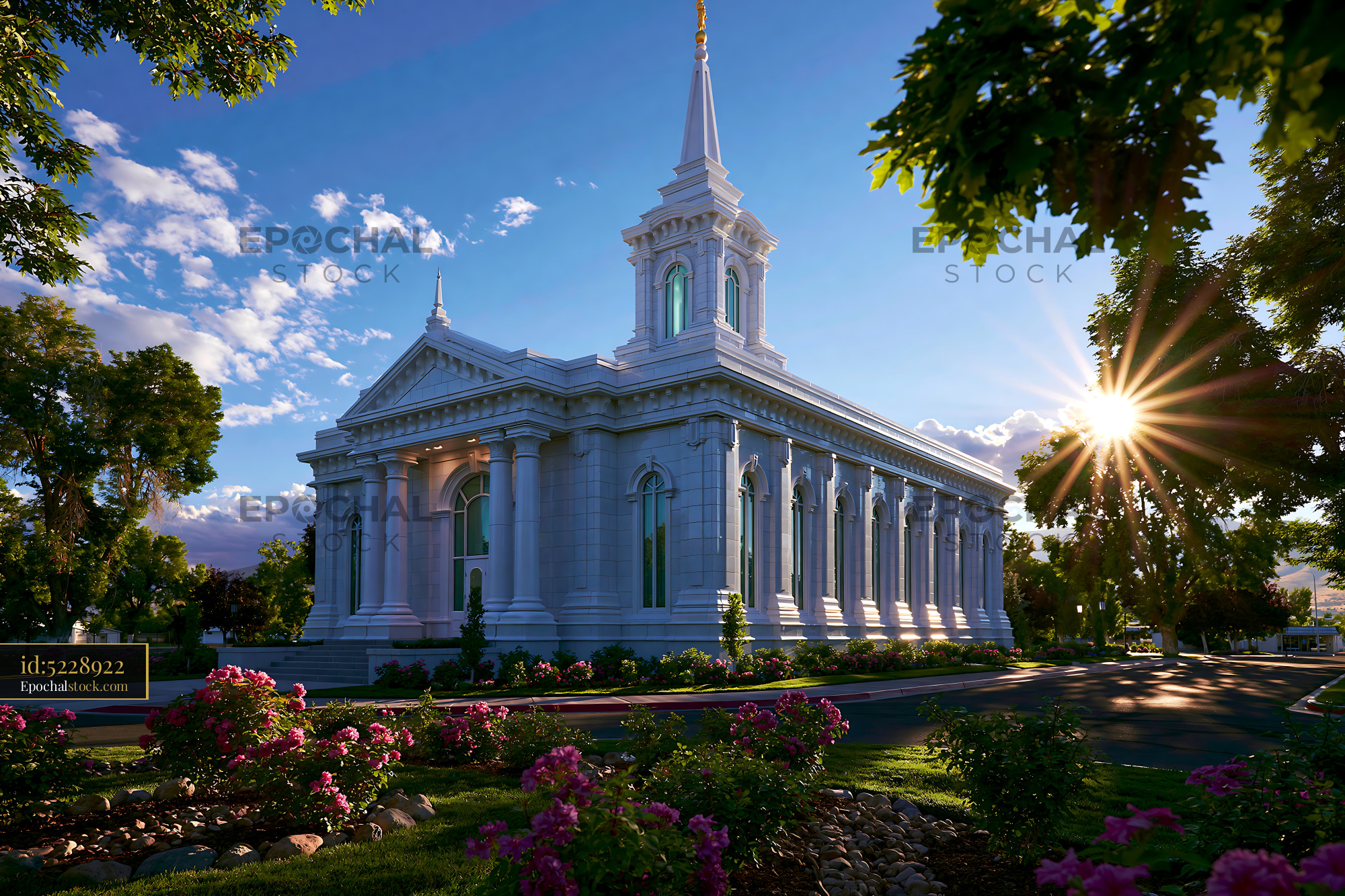 Watermarked full-resolution preview of Church building with a tall spire surrounded by flowers at sunset