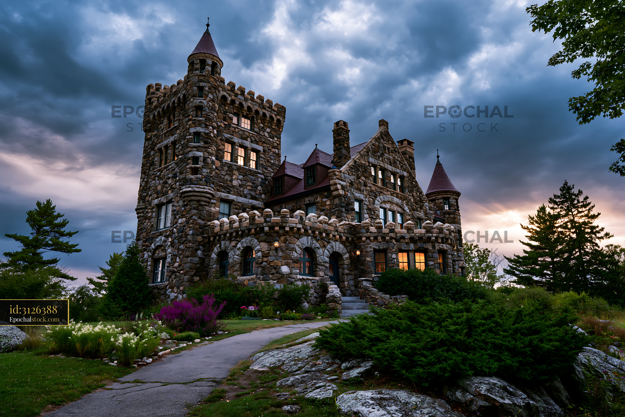 Watermarked full-resolution preview of Historic stone castle under a cloudy sky at sunset