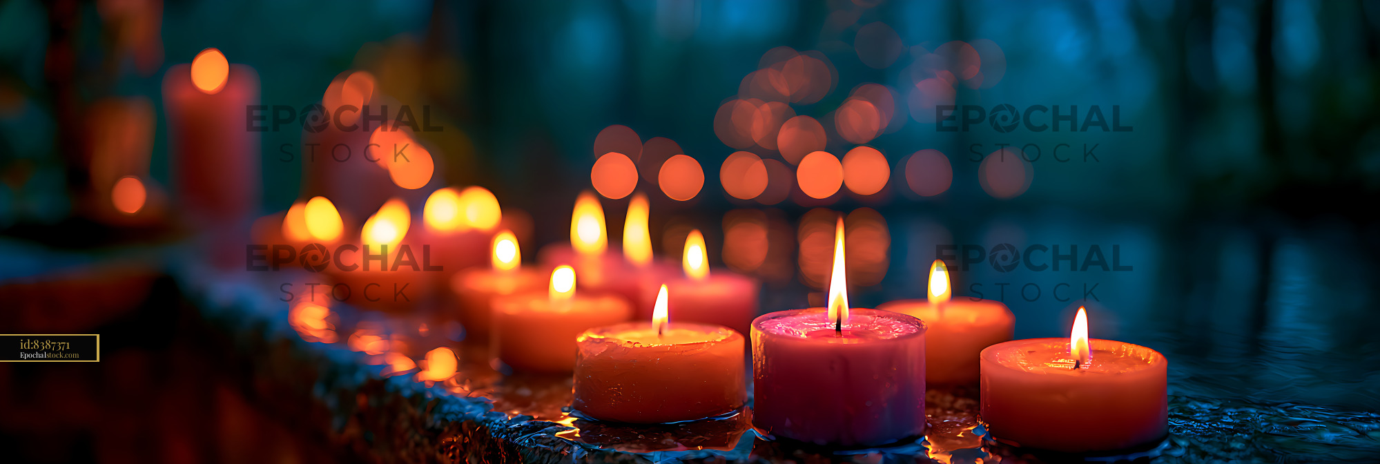 Watermarked full-resolution preview of Colorful burning candles with warm bokeh background