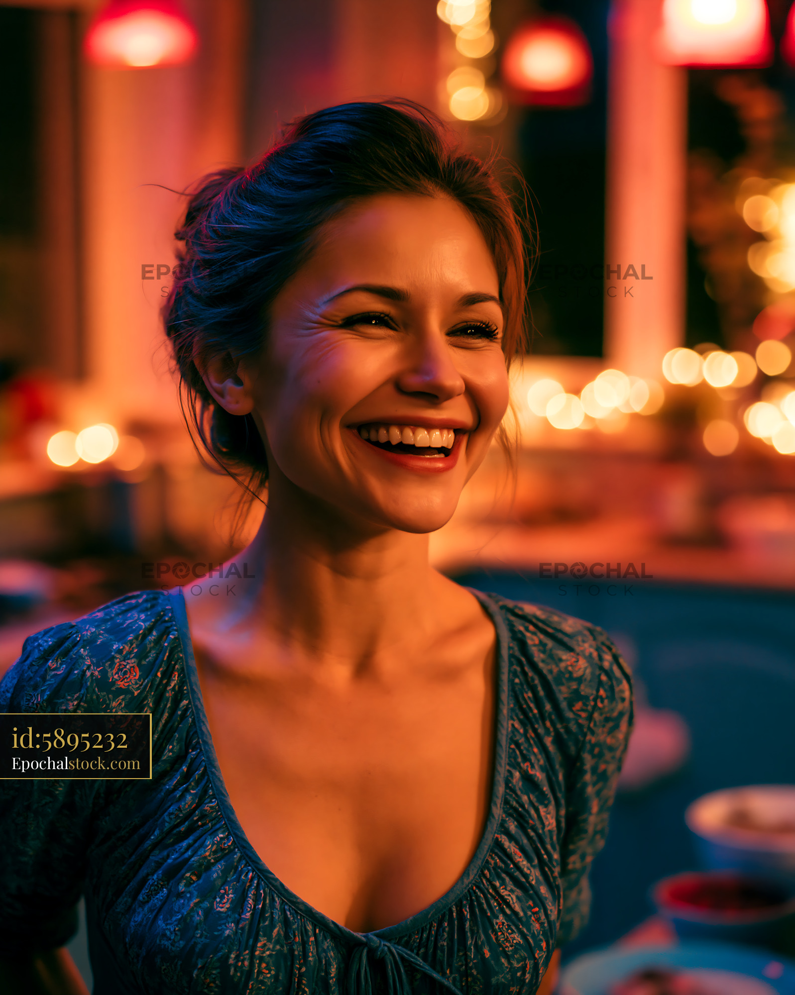 Watermarked full-resolution preview of Woman smiling in a warmly lit kitchen during a cozy gathering