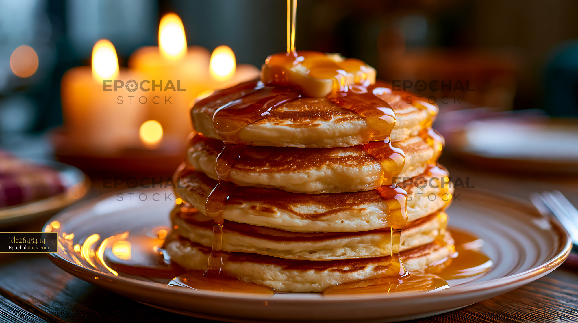 Watermarked full-resolution preview of Pancake stack with syrup and butter in warm candlelight