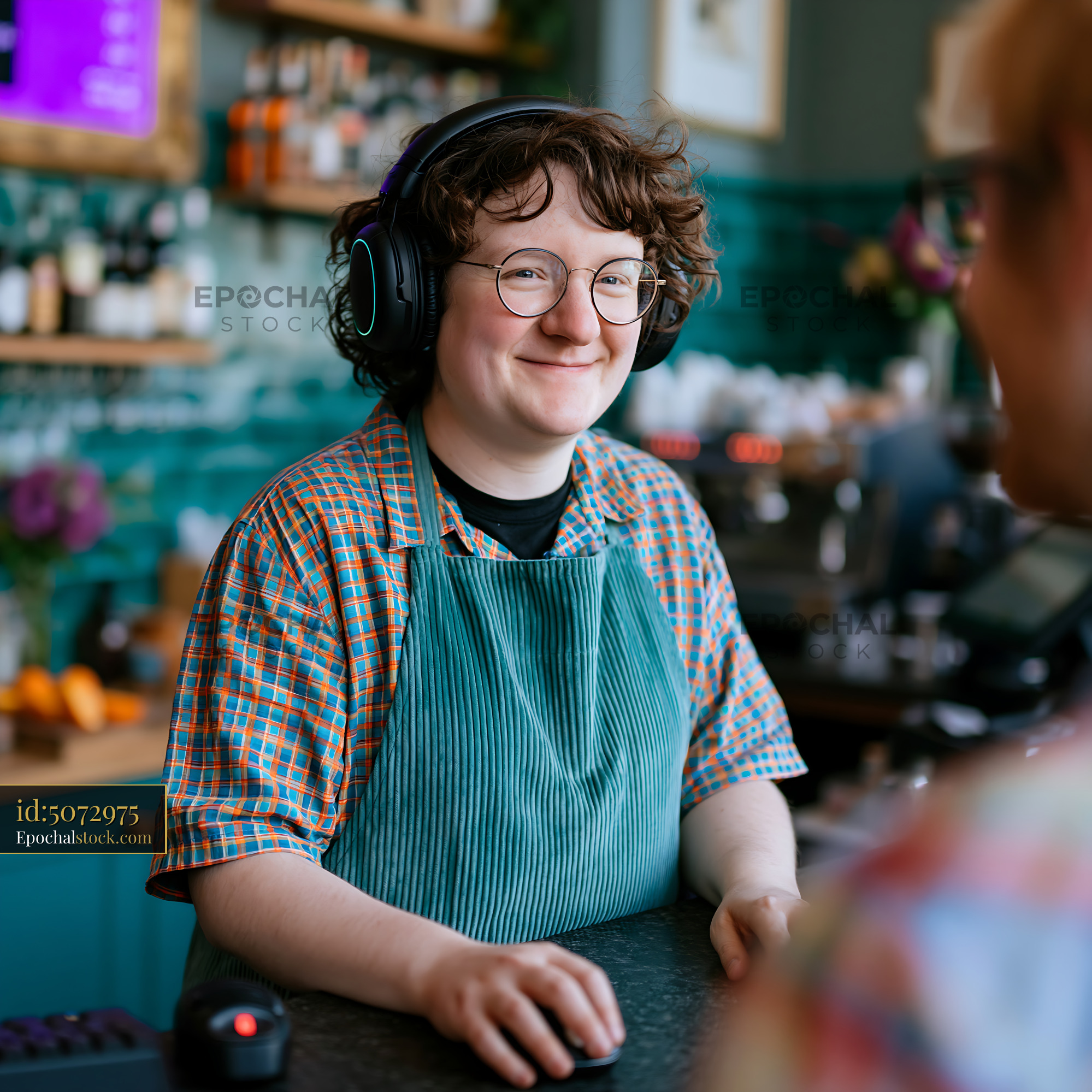 Watermarked full-resolution preview of Barista serving coffee at a cafe with headphones